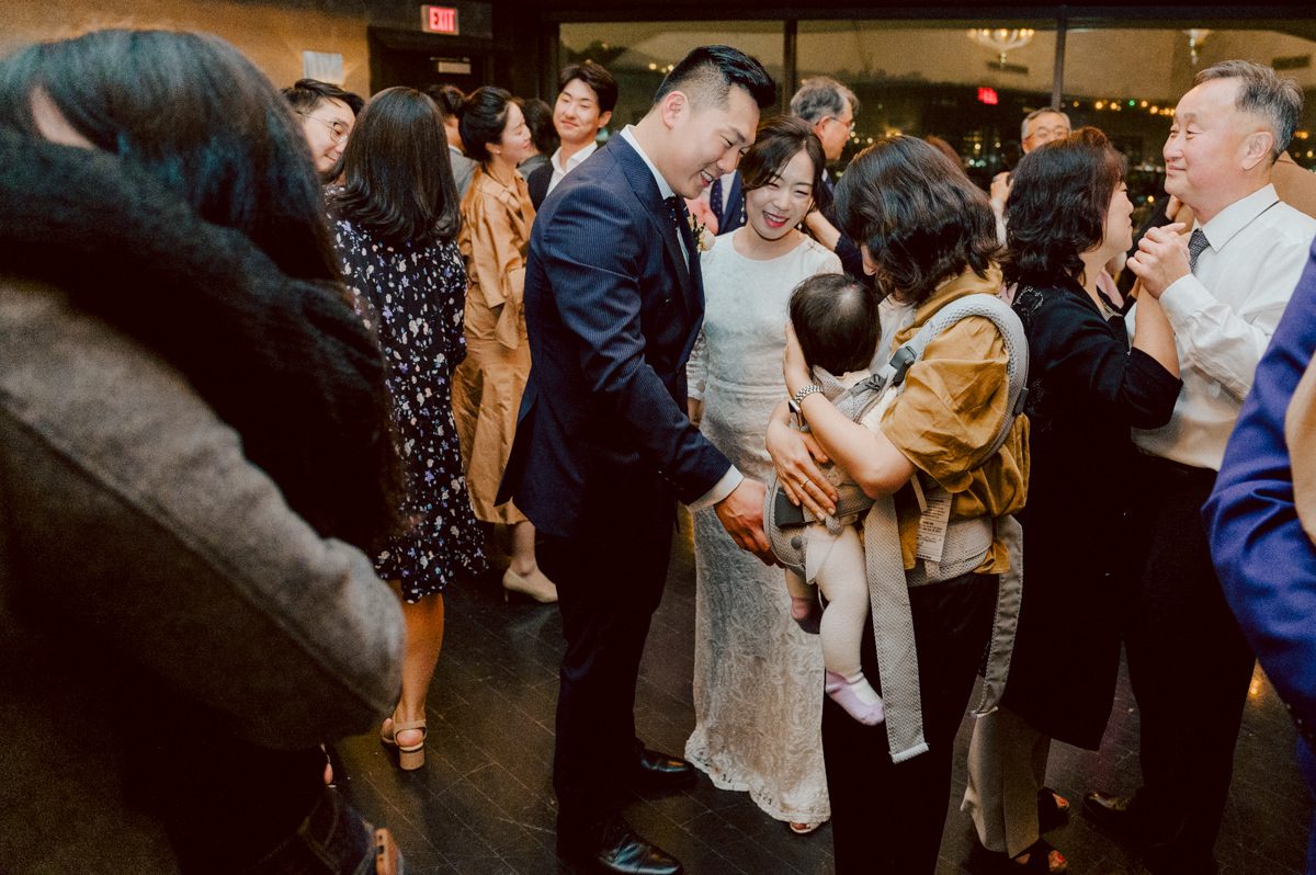 Chloe and Bosco are one of the sweetest couple!!! Well mannered, kind, sweet, considerate so I was extra excited for Chloe and Bosco's wedding at The Chart House. Chloe and Bosco both got ready at Chole's parents house in Oradell NJ where both sets of parents were all gathered. With no bridal party Chloe and Bosco had a quiet wedding morning. Midway through the morning prep, it started raining outside and did not look like we will be going outside for photos anytime soon or even till evening at Weehawken. With wishful mind of clear sky later, we got photos with family, parents and the couple at Chole's parent's house before leaving for Chloe and Bosco's wedding ceremony at St. Michaels Church in Fort Lee, NJ. St. Michales Church is small cute Korean Catholic church in Fort Lee, NJ where Chloe and Bosco belongs to. We can hear the rain falling down harder while getting group and family formal photos at St. Michaels Church before heading to Chart House in Weehawken NJ for Chloe and Bosco's intimate wedding reception. By the time we were in the car to drive over to Chart House, it was POURING. Chart House was busy with weekend customers enjoying the restaurant and they had three events going on upstairs! The entrance to Chart House was crowded with people coming and leaving waiting for the valet to bring their cars. Chloe and Bosco with help of their friends DIYed lots of wedding decor, music and games/entertainment during their wedding reception at Chart House. My heart really belongs to these small and intimate weddings where the couple focuses on them and what is really important to them instead of a big wedding celebration to show off of copy what they saw on social media. Sweet and lovely intimate wedding of Chloe and Bosco at Chart House Weehawken NJ wedding documented by by Karis | Hey Karis | Catskills, Hudson Valley NY elopement and wedding photographer | Brooklyn NY elopement and wedding photographer | Manhattan NY elopement and wedding photographer | Hey Karis is fun documentary wedding and elopement photographer.
