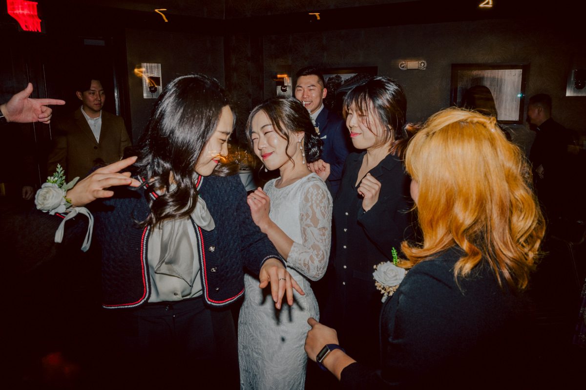 Chloe and Bosco are one of the sweetest couple!!! Well mannered, kind, sweet, considerate so I was extra excited for Chloe and Bosco's wedding at The Chart House. Chloe and Bosco both got ready at Chole's parents house in Oradell NJ where both sets of parents were all gathered. With no bridal party Chloe and Bosco had a quiet wedding morning. Midway through the morning prep, it started raining outside and did not look like we will be going outside for photos anytime soon or even till evening at Weehawken. With wishful mind of clear sky later, we got photos with family, parents and the couple at Chole's parent's house before leaving for Chloe and Bosco's wedding ceremony at St. Michaels Church in Fort Lee, NJ. St. Michales Church is small cute Korean Catholic church in Fort Lee, NJ where Chloe and Bosco belongs to. We can hear the rain falling down harder while getting group and family formal photos at St. Michaels Church before heading to Chart House in Weehawken NJ for Chloe and Bosco's intimate wedding reception. By the time we were in the car to drive over to Chart House, it was POURING. Chart House was busy with weekend customers enjoying the restaurant and they had three events going on upstairs! The entrance to Chart House was crowded with people coming and leaving waiting for the valet to bring their cars. Chloe and Bosco with help of their friends DIYed lots of wedding decor, music and games/entertainment during their wedding reception at Chart House. My heart really belongs to these small and intimate weddings where the couple focuses on them and what is really important to them instead of a big wedding celebration to show off of copy what they saw on social media. Sweet and lovely intimate wedding of Chloe and Bosco at Chart House Weehawken NJ wedding documented by by Karis | Hey Karis | Catskills, Hudson Valley NY elopement and wedding photographer | Brooklyn NY elopement and wedding photographer | Manhattan NY elopement and wedding photographer | Hey Karis is fun documentary wedding and elopement photographer.
