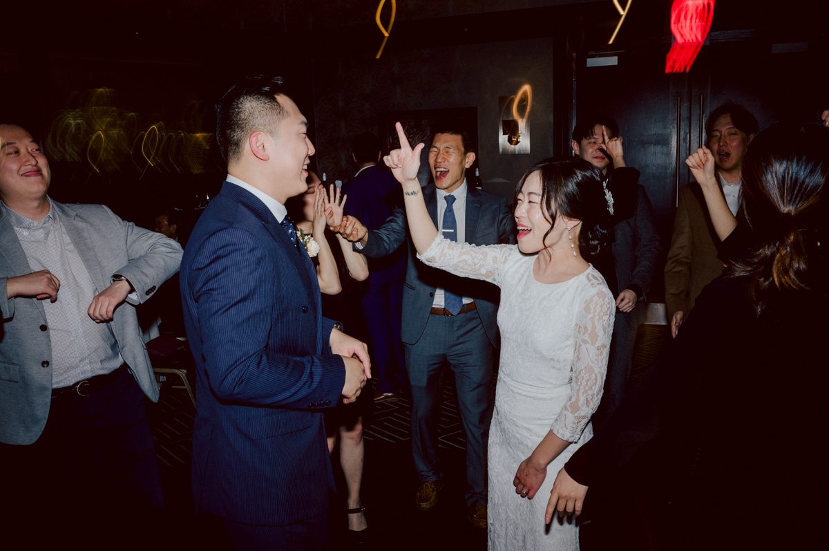 Chloe and Bosco are one of the sweetest couple!!! Well mannered, kind, sweet, considerate so I was extra excited for Chloe and Bosco's wedding at The Chart House. Chloe and Bosco both got ready at Chole's parents house in Oradell NJ where both sets of parents were all gathered. With no bridal party Chloe and Bosco had a quiet wedding morning. Midway through the morning prep, it started raining outside and did not look like we will be going outside for photos anytime soon or even till evening at Weehawken. With wishful mind of clear sky later, we got photos with family, parents and the couple at Chole's parent's house before leaving for Chloe and Bosco's wedding ceremony at St. Michaels Church in Fort Lee, NJ. St. Michales Church is small cute Korean Catholic church in Fort Lee, NJ where Chloe and Bosco belongs to. We can hear the rain falling down harder while getting group and family formal photos at St. Michaels Church before heading to Chart House in Weehawken NJ for Chloe and Bosco's intimate wedding reception. By the time we were in the car to drive over to Chart House, it was POURING. Chart House was busy with weekend customers enjoying the restaurant and they had three events going on upstairs! The entrance to Chart House was crowded with people coming and leaving waiting for the valet to bring their cars. Chloe and Bosco with help of their friends DIYed lots of wedding decor, music and games/entertainment during their wedding reception at Chart House. My heart really belongs to these small and intimate weddings where the couple focuses on them and what is really important to them instead of a big wedding celebration to show off of copy what they saw on social media. Sweet and lovely intimate wedding of Chloe and Bosco at Chart House Weehawken NJ wedding documented by by Karis | Hey Karis | Catskills, Hudson Valley NY elopement and wedding photographer | Brooklyn NY elopement and wedding photographer | Manhattan NY elopement and wedding photographer | Hey Karis is fun documentary wedding and elopement photographer.
