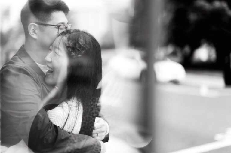 As I was about to walk into Ridgewood Coffee Company on Ridgewood Ave I saw Jane and Kevin walking out of their car. Kevin's face brightened up into big smile and came over to give me a hug then Jane turning and saw me. Jane and Kevin are one of those people that really appreciates me, big huge fans of my work and I am so honored to have earned their trust and love. Jane and Kevin are my people and they are my tribe. I love love shooting at small downtown because of it's variety of backdrops, every corner is different, new, exciting. It was such a joy wandering around downtown Ridgewood with two people that would do anything that I tell them to. Jane and Kevin were such a delightful people, they make me laugh and smile if I think of them. I can't wait to celebrate with them again on their wedding at Tides Estate till then these adorable and fun engagement photo will have to do. Jane and Kevin's Downtown Ridgewood NJ egagement Session documented by by Karis | Hey Karis | Catskills, Hudson Valley NY elopement and wedding photographer | Brooklyn NY elopement and wedding photographer | Manhattan NY elopement and wedding photographer | Hey Karis is fun documentary wedding and elopement photographer.