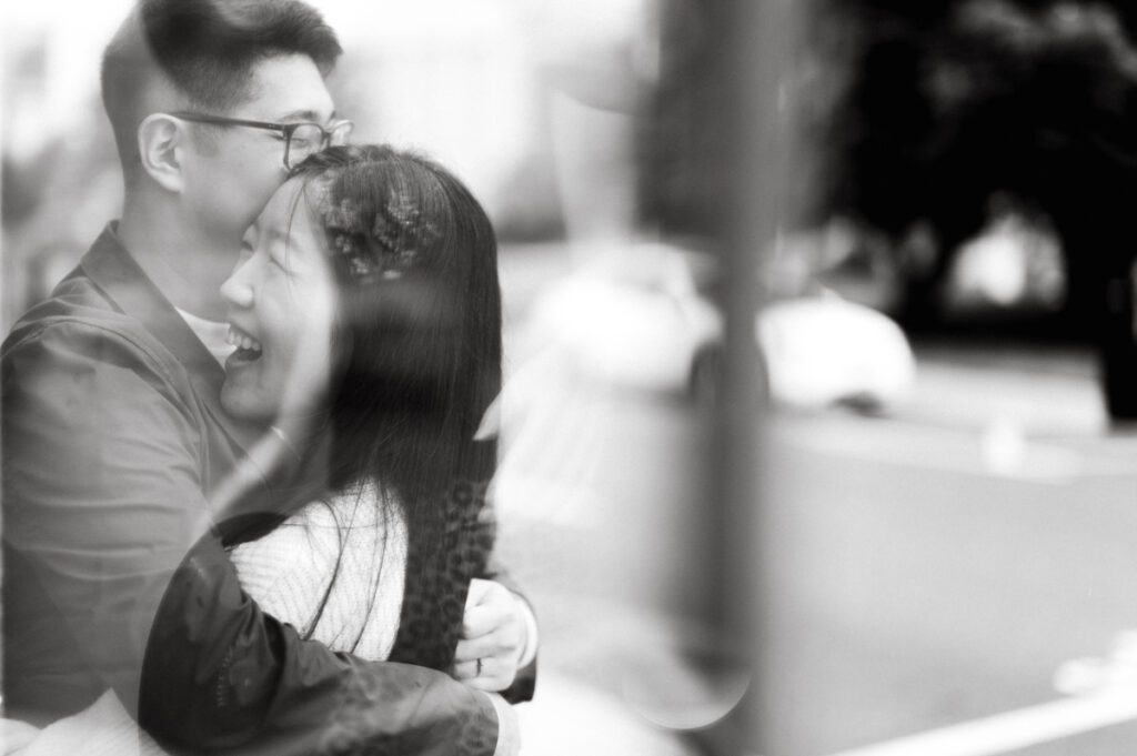 As I was about to walk into Ridgewood Coffee Company on Ridgewood Ave I saw Jane and Kevin walking out of their car. Kevin's face brightened up into big smile and came over to give me a hug then Jane turning and saw me. Jane and Kevin are one of those people that really appreciates me, big huge fans of my work and I am so honored to have earned their trust and love. Jane and Kevin are my people and they are my tribe. I love love shooting at small downtown because of it's variety of backdrops, every corner is different, new, exciting. It was such a joy wandering around downtown Ridgewood with two people that would do anything that I tell them to. Jane and Kevin were such a delightful people, they make me laugh and smile if I think of them. I can't wait to celebrate with them again on their wedding at Tides Estate till then these adorable and fun engagement photo will have to do. Jane and Kevin's Downtown Ridgewood NJ egagement Session documented by by Karis | Hey Karis | Catskills, Hudson Valley NY elopement and wedding photographer | Brooklyn NY elopement and wedding photographer | Manhattan NY elopement and wedding photographer | Hey Karis is fun documentary wedding and elopement photographer.