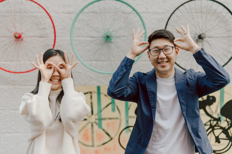 As I was about to walk into Ridgewood Coffee Company on Ridgewood Ave I saw Jane and Kevin walking out of their car. Kevin's face brightened up into big smile and came over to give me a hug then Jane turning and saw me. Jane and Kevin are one of those people that really appreciates me, big huge fans of my work and I am so honored to have earned their trust and love. Jane and Kevin are my people and they are my tribe. I love love shooting at small downtown because of it's variety of backdrops, every corner is different, new, exciting. It was such a joy wandering around downtown Ridgewood with two people that would do anything that I tell them to. Jane and Kevin were such a delightful people, they make me laugh and smile if I think of them. I can't wait to celebrate with them again on their wedding at Tides Estate till then these adorable and fun engagement photo will have to do. Jane and Kevin's Downtown Ridgewood NJ egagement Session documented by by Karis | Hey Karis | Catskills, Hudson Valley NY elopement and wedding photographer | Brooklyn NY elopement and wedding photographer | Manhattan NY elopement and wedding photographer | Hey Karis is fun documentary wedding and elopement photographer.