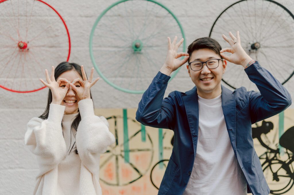 As I was about to walk into Ridgewood Coffee Company on Ridgewood Ave I saw Jane and Kevin walking out of their car. Kevin's face brightened up into big smile and came over to give me a hug then Jane turning and saw me. Jane and Kevin are one of those people that really appreciates me, big huge fans of my work and I am so honored to have earned their trust and love. Jane and Kevin are my people and they are my tribe. I love love shooting at small downtown because of it's variety of backdrops, every corner is different, new, exciting. It was such a joy wandering around downtown Ridgewood with two people that would do anything that I tell them to. Jane and Kevin were such a delightful people, they make me laugh and smile if I think of them. I can't wait to celebrate with them again on their wedding at Tides Estate till then these adorable and fun engagement photo will have to do. Jane and Kevin's Downtown Ridgewood NJ egagement Session documented by by Karis | Hey Karis | Catskills, Hudson Valley NY elopement and wedding photographer | Brooklyn NY elopement and wedding photographer | Manhattan NY elopement and wedding photographer | Hey Karis is fun documentary wedding and elopement photographer.