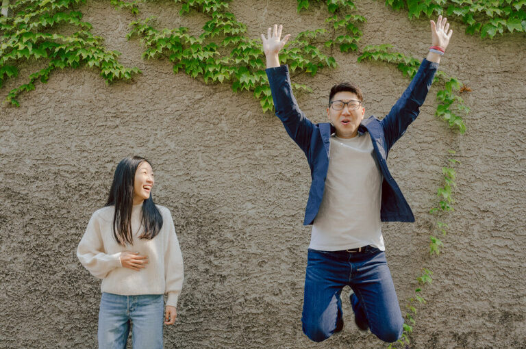 As I was about to walk into Ridgewood Coffee Company on Ridgewood Ave I saw Jane and Kevin walking out of their car. Kevin's face brightened up into big smile and came over to give me a hug then Jane turning and saw me. Jane and Kevin are one of those people that really appreciates me, big huge fans of my work and I am so honored to have earned their trust and love. Jane and Kevin are my people and they are my tribe. I love love shooting at small downtown because of it's variety of backdrops, every corner is different, new, exciting. It was such a joy wandering around downtown Ridgewood with two people that would do anything that I tell them to. Jane and Kevin were such a delightful people, they make me laugh and smile if I think of them. I can't wait to celebrate with them again on their wedding at Tides Estate till then these adorable and fun engagement photo will have to do. Jane and Kevin's Downtown Ridgewood NJ egagement Session documented by by Karis | Hey Karis | Catskills, Hudson Valley NY elopement and wedding photographer | Brooklyn NY elopement and wedding photographer | Manhattan NY elopement and wedding photographer | Hey Karis is fun documentary wedding and elopement photographer.