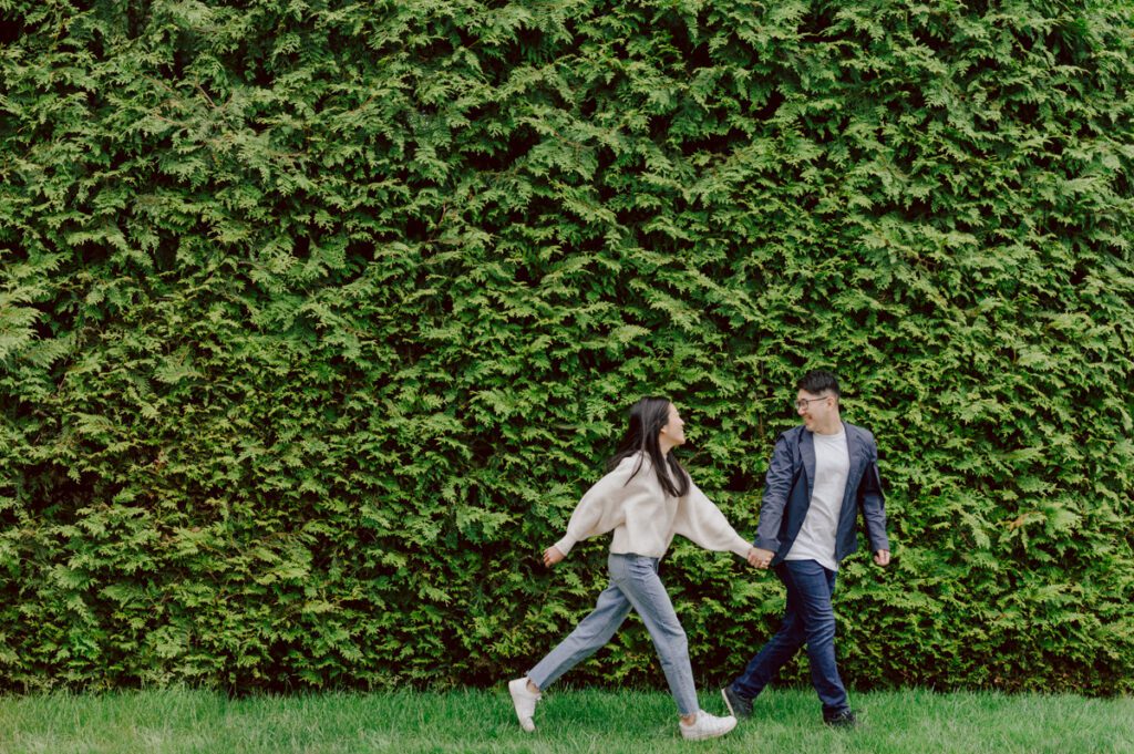 As I was about to walk into Ridgewood Coffee Company on Ridgewood Ave I saw Jane and Kevin walking out of their car. Kevin's face brightened up into big smile and came over to give me a hug then Jane turning and saw me. Jane and Kevin are one of those people that really appreciates me, big huge fans of my work and I am so honored to have earned their trust and love. Jane and Kevin are my people and they are my tribe. I love love shooting at small downtown because of it's variety of backdrops, every corner is different, new, exciting. It was such a joy wandering around downtown Ridgewood with two people that would do anything that I tell them to. Jane and Kevin were such a delightful people, they make me laugh and smile if I think of them. I can't wait to celebrate with them again on their wedding at Tides Estate till then these adorable and fun engagement photo will have to do. Jane and Kevin's Downtown Ridgewood NJ egagement Session documented by by Karis | Hey Karis | Catskills, Hudson Valley NY elopement and wedding photographer | Brooklyn NY elopement and wedding photographer | Manhattan NY elopement and wedding photographer | Hey Karis is fun documentary wedding and elopement photographer.