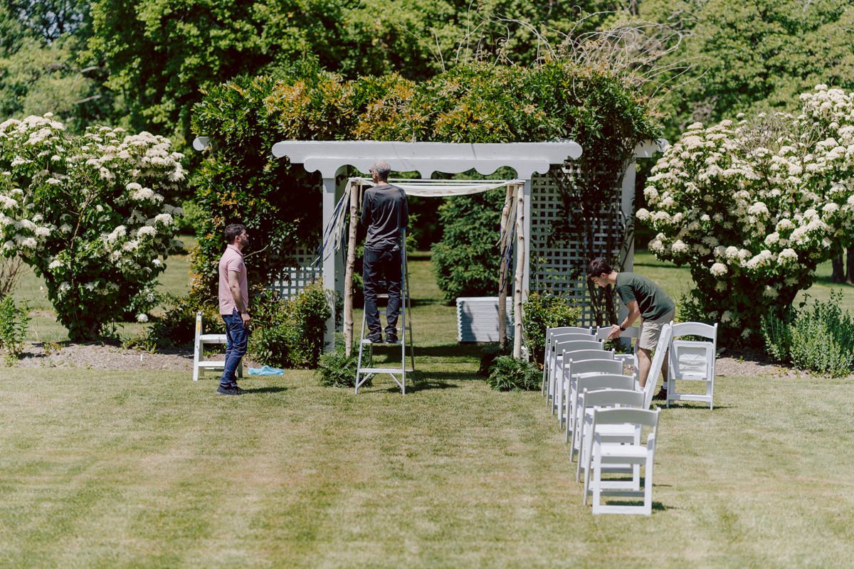 Woolverton Inn located in Stockton NJ is truly one of a kind magical place in NJ. Woolverton Inn is a bed and breakfast with 14 cottages and guest rooms which is perfect way to celebrate your wedding for the whole weekend with family and friends. Tara and Matt along with their family spent the whole weekend at Woolverton Inn celebrating their wedding. Tara and Matt's goal for their wedding was to have an intimate, chill and relaxed wedding weekend with their loved ones. No bridal party, no formalities, no rules but Tara and Matt only wanted to celebrate their wedding their way. No cheesy entrances, no sleazy DJ and no awkward parent dances, but instead they had a classic band "Dennis Pol Music" playing jazz music into the dark night. It was perfect weather, perfect evening to be having a tent wedding at Woolverton Inn. Tara and Matt woke up to get ready for their wedding at Woolverton Inn. Beauty and the Blush team was doing hair/makeup and soon Tara got into her pink Alexander McQueen wedding dress. I loved everything about Tara and Matt's wedding at Woolverton Inn from how chill and relaxed it was, Tara's pink Alexander McQueen wedding dress, and the fact that there was absolutely no bridal party! Focusing on the two people, bride and groom was only thing that mattered on Tara and Matt's wedding day. Tara and Matt's Woolverton Inn garden wedding ceremony was beautiful and sweet. Tara and Matt's cocktail hour at Woolverton Inn was like a gorgeous painting. Then when the cocktail hour ended guests walked along the path to the tent where the reception was held and on the way to the tent Tara and Matt stopped by the Sheep to get some photos with the adorable Woolverton Inn's most social most famous Miss Annie the sheep. Miss Annie is only sheep at Woolverton that is not afraid of people so when the snacks came out Miss Annie instantly ran over to tara and Matt. The rest of the evening, Tara and Matt walked around the tent talking to every single guests with amazing food and drinks Tara and Matt celebrated their wedding at Woolverton Inn exact way they wanted to and it was perfect! Tara and Matt's Woolverton Inn Stockton NJ wedding documented by by Karis | Hey Karis | Catskills, Hudson Valley NY elopement and wedding photographer | Brooklyn NY elopement and wedding photographer | Manhattan NY elopement and wedding photographer | Hey Karis is fun documentary wedding and elopement photographer.