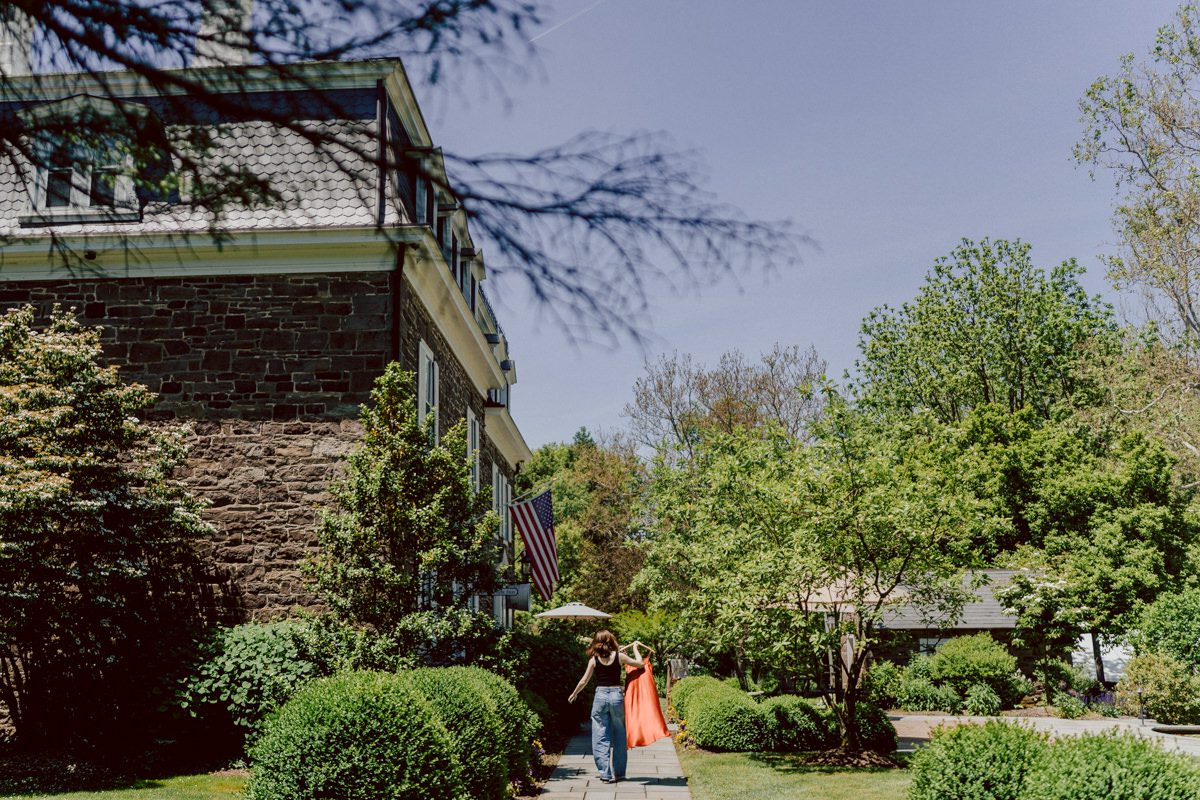 Woolverton Inn located in Stockton NJ is truly one of a kind magical place in NJ. Woolverton Inn is a bed and breakfast with 14 cottages and guest rooms which is perfect way to celebrate your wedding for the whole weekend with family and friends. Tara and Matt along with their family spent the whole weekend at Woolverton Inn celebrating their wedding. Tara and Matt's goal for their wedding was to have an intimate, chill and relaxed wedding weekend with their loved ones. No bridal party, no formalities, no rules but Tara and Matt only wanted to celebrate their wedding their way. No cheesy entrances, no sleazy DJ and no awkward parent dances, but instead they had a classic band "Dennis Pol Music" playing jazz music into the dark night. It was perfect weather, perfect evening to be having a tent wedding at Woolverton Inn. Tara and Matt woke up to get ready for their wedding at Woolverton Inn. Beauty and the Blush team was doing hair/makeup and soon Tara got into her pink Alexander McQueen wedding dress. I loved everything about Tara and Matt's wedding at Woolverton Inn from how chill and relaxed it was, Tara's pink Alexander McQueen wedding dress, and the fact that there was absolutely no bridal party! Focusing on the two people, bride and groom was only thing that mattered on Tara and Matt's wedding day. Tara and Matt's Woolverton Inn garden wedding ceremony was beautiful and sweet. Tara and Matt's cocktail hour at Woolverton Inn was like a gorgeous painting. Then when the cocktail hour ended guests walked along the path to the tent where the reception was held and on the way to the tent Tara and Matt stopped by the Sheep to get some photos with the adorable Woolverton Inn's most social most famous Miss Annie the sheep. Miss Annie is only sheep at Woolverton that is not afraid of people so when the snacks came out Miss Annie instantly ran over to tara and Matt. The rest of the evening, Tara and Matt walked around the tent talking to every single guests with amazing food and drinks Tara and Matt celebrated their wedding at Woolverton Inn exact way they wanted to and it was perfect! Tara and Matt's Woolverton Inn Stockton NJ wedding documented by by Karis | Hey Karis | Catskills, Hudson Valley NY elopement and wedding photographer | Brooklyn NY elopement and wedding photographer | Manhattan NY elopement and wedding photographer | Hey Karis is fun documentary wedding and elopement photographer.