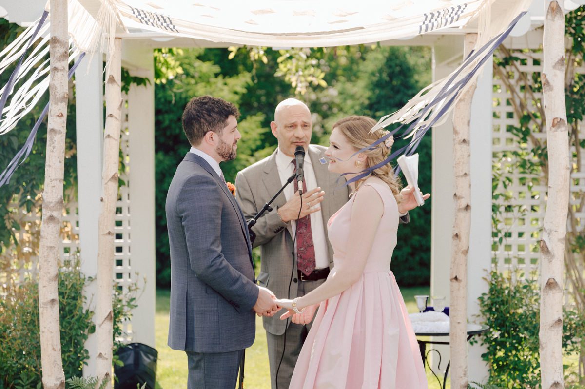 Woolverton Inn located in Stockton NJ is truly one of a kind magical place in NJ. Woolverton Inn is a bed and breakfast with 14 cottages and guest rooms which is perfect way to celebrate your wedding for the whole weekend with family and friends. Tara and Matt along with their family spent the whole weekend at Woolverton Inn celebrating their wedding. Tara and Matt's goal for their wedding was to have an intimate, chill and relaxed wedding weekend with their loved ones. No bridal party, no formalities, no rules but Tara and Matt only wanted to celebrate their wedding their way. No cheesy entrances, no sleazy DJ and no awkward parent dances, but instead they had a classic band "Dennis Pol Music" playing jazz music into the dark night. It was perfect weather, perfect evening to be having a tent wedding at Woolverton Inn. Tara and Matt woke up to get ready for their wedding at Woolverton Inn. Beauty and the Blush team was doing hair/makeup and soon Tara got into her pink Alexander McQueen wedding dress. I loved everything about Tara and Matt's wedding at Woolverton Inn from how chill and relaxed it was, Tara's pink Alexander McQueen wedding dress, and the fact that there was absolutely no bridal party! Focusing on the two people, bride and groom was only thing that mattered on Tara and Matt's wedding day. Tara and Matt's Woolverton Inn garden wedding ceremony was beautiful and sweet. Tara and Matt's cocktail hour at Woolverton Inn was like a gorgeous painting. Then when the cocktail hour ended guests walked along the path to the tent where the reception was held and on the way to the tent Tara and Matt stopped by the Sheep to get some photos with the adorable Woolverton Inn's most social most famous Miss Annie the sheep. Miss Annie is only sheep at Woolverton that is not afraid of people so when the snacks came out Miss Annie instantly ran over to tara and Matt. The rest of the evening, Tara and Matt walked around the tent talking to every single guests with amazing food and drinks Tara and Matt celebrated their wedding at Woolverton Inn exact way they wanted to and it was perfect! Tara and Matt's Woolverton Inn Stockton NJ wedding documented by by Karis | Hey Karis | Catskills, Hudson Valley NY elopement and wedding photographer | Brooklyn NY elopement and wedding photographer | Manhattan NY elopement and wedding photographer | Hey Karis is fun documentary wedding and elopement photographer.