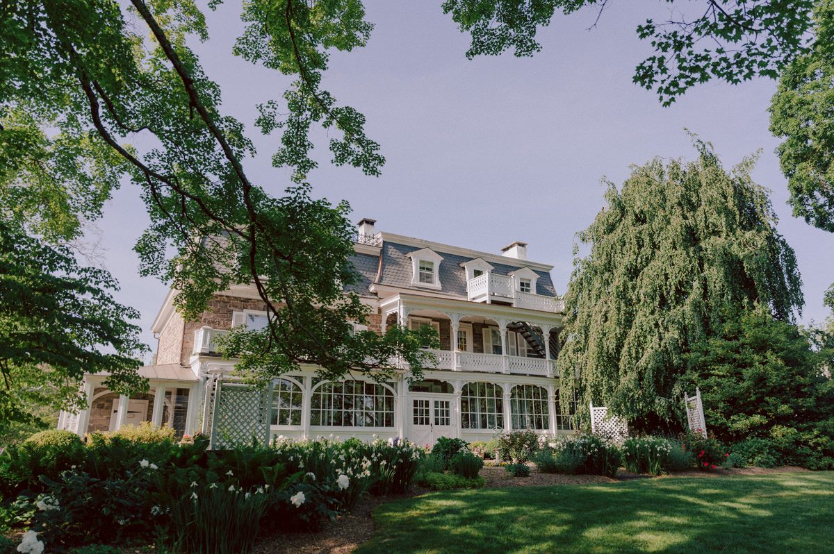 Woolverton Inn located in Stockton NJ is truly one of a kind magical place in NJ. Woolverton Inn is a bed and breakfast with 14 cottages and guest rooms which is perfect way to celebrate your wedding for the whole weekend with family and friends. Tara and Matt along with their family spent the whole weekend at Woolverton Inn celebrating their wedding. Tara and Matt's goal for their wedding was to have an intimate, chill and relaxed wedding weekend with their loved ones. No bridal party, no formalities, no rules but Tara and Matt only wanted to celebrate their wedding their way. No cheesy entrances, no sleazy DJ and no awkward parent dances, but instead they had a classic band "Dennis Pol Music" playing jazz music into the dark night. It was perfect weather, perfect evening to be having a tent wedding at Woolverton Inn. Tara and Matt woke up to get ready for their wedding at Woolverton Inn. Beauty and the Blush team was doing hair/makeup and soon Tara got into her pink Alexander McQueen wedding dress. I loved everything about Tara and Matt's wedding at Woolverton Inn from how chill and relaxed it was, Tara's pink Alexander McQueen wedding dress, and the fact that there was absolutely no bridal party! Focusing on the two people, bride and groom was only thing that mattered on Tara and Matt's wedding day. Tara and Matt's Woolverton Inn garden wedding ceremony was beautiful and sweet. Tara and Matt's cocktail hour at Woolverton Inn was like a gorgeous painting. Then when the cocktail hour ended guests walked along the path to the tent where the reception was held and on the way to the tent Tara and Matt stopped by the Sheep to get some photos with the adorable Woolverton Inn's most social most famous Miss Annie the sheep. Miss Annie is only sheep at Woolverton that is not afraid of people so when the snacks came out Miss Annie instantly ran over to tara and Matt. The rest of the evening, Tara and Matt walked around the tent talking to every single guests with amazing food and drinks Tara and Matt celebrated their wedding at Woolverton Inn exact way they wanted to and it was perfect! Tara and Matt's Woolverton Inn Stockton NJ wedding documented by by Karis | Hey Karis | Catskills, Hudson Valley NY elopement and wedding photographer | Brooklyn NY elopement and wedding photographer | Manhattan NY elopement and wedding photographer | Hey Karis is fun documentary wedding and elopement photographer.