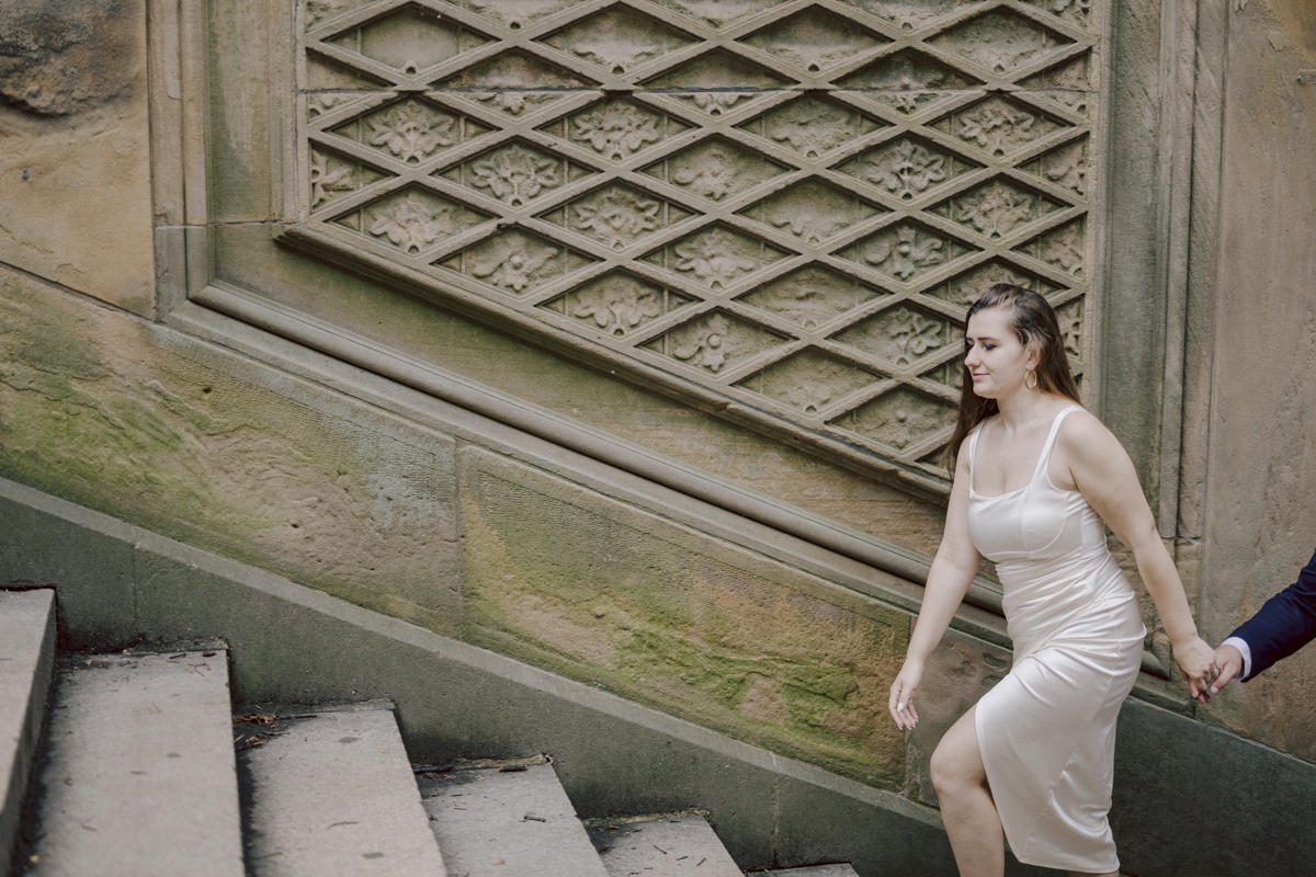 After trying to dodge multiple rains, scattered thunderstorms we met by Bethesda Fountain in Central Park NY. I saw Izzy and Brendan standing near crowded Bethesda Arcade. Dressed for their engagement session I took Izzy and Brendan to quiet corner of this jam packed Central Park. With maximum humidity in the air Izzy and Brendan was such a troopers in this heavy heat with crazy humidity in the air they smiles, laughed and cursed. The good ol'NY way, together with Izzy and Brendan we were weird, sarcastic, funny walking around Central Park. At some point it actually started drizzling then turned into heavy rain but we took covers under the trees and continued shooting. It was so fun photographing two people who cared less about how they looked in the humidity but just wanted to have fun! Again I love my careless, self loving humans and can't wait for Izzy and Brendan's wedding at Arrow Park this year. Izzy and Brendan's Central Park NY engagement documented by by Karis | Hey Karis | Catskills, Hudson Valley NY elopement and wedding photographer | Brooklyn NY elopement and wedding photographer | Manhattan NY elopement and wedding photographer | Hey Karis is fun documentary wedding and elopement photographer.
