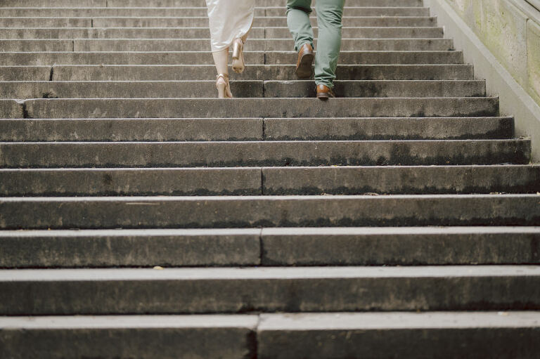 After trying to dodge multiple rains, scattered thunderstorms we met by Bethesda Fountain in Central Park NY. I saw Izzy and Brendan standing near crowded Bethesda Arcade. Dressed for their engagement session I took Izzy and Brendan to quiet corner of this jam packed Central Park. With maximum humidity in the air Izzy and Brendan was such a troopers in this heavy heat with crazy humidity in the air they smiles, laughed and cursed. The good ol'NY way, together with Izzy and Brendan we were weird, sarcastic, funny walking around Central Park. At some point it actually started drizzling then turned into heavy rain but we took covers under the trees and continued shooting. It was so fun photographing two people who cared less about how they looked in the humidity but just wanted to have fun! Again I love my careless, self loving humans and can't wait for Izzy and Brendan's wedding at Arrow Park this year. Izzy and Brendan's Central Park NY engagement documented by by Karis | Hey Karis | Catskills, Hudson Valley NY elopement and wedding photographer | Brooklyn NY elopement and wedding photographer | Manhattan NY elopement and wedding photographer | Hey Karis is fun documentary wedding and elopement photographer.
