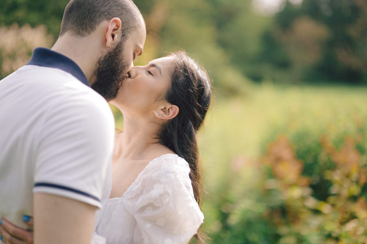 Ari and Kevin reached out with an intimate wedding plans and was pretty much ready to book me as soon as they got on the phone. Most intimate wedding couples opt out of engagement session but Ari knew she wanted an engagement session to celebrate their love before their intimate wedding in August. Ari and Kevin have very active lifestyle where they go climbing, hiking, running, etc...so by default they wanted an outdoor natury engagement session. We chose to meet at the botanical garden. Since we are in the middle of hot summer, we all agreed on early session when the park opened but even than 30mins into the engagement session it got real hot and humid. Ari not so much but Kevin was definitely started sweating. But Ari and Kevin along with their Corgi named Echo did amazing, we had so much fun as you can see from these photos of Ari, Kevin and Echo. Ari and Kevin's Botanical Garden engagement documented by by Karis | Hey Karis | Catskills, Hudson Valley NY elopement and wedding photographer | Brooklyn NY elopement and wedding photographer | Manhattan NY elopement and wedding photographer | Hey Karis is fun documentary wedding and elopement photographer.