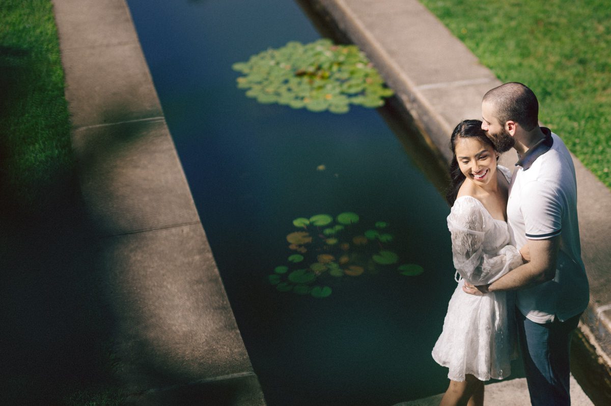 Ari and Kevin reached out with an intimate wedding plans and was pretty much ready to book me as soon as they got on the phone. Most intimate wedding couples opt out of engagement session but Ari knew she wanted an engagement session to celebrate their love before their intimate wedding in August. Ari and Kevin have very active lifestyle where they go climbing, hiking, running, etc...so by default they wanted an outdoor natury engagement session. We chose to meet at the botanical garden. Since we are in the middle of hot summer, we all agreed on early session when the park opened but even than 30mins into the engagement session it got real hot and humid. Ari not so much but Kevin was definitely started sweating. But Ari and Kevin along with their Corgi named Echo did amazing, we had so much fun as you can see from these photos of Ari, Kevin and Echo. Ari and Kevin's Botanical Garden engagement documented by by Karis | Hey Karis | Catskills, Hudson Valley NY elopement and wedding photographer | Brooklyn NY elopement and wedding photographer | Manhattan NY elopement and wedding photographer | Hey Karis is fun documentary wedding and elopement photographer.