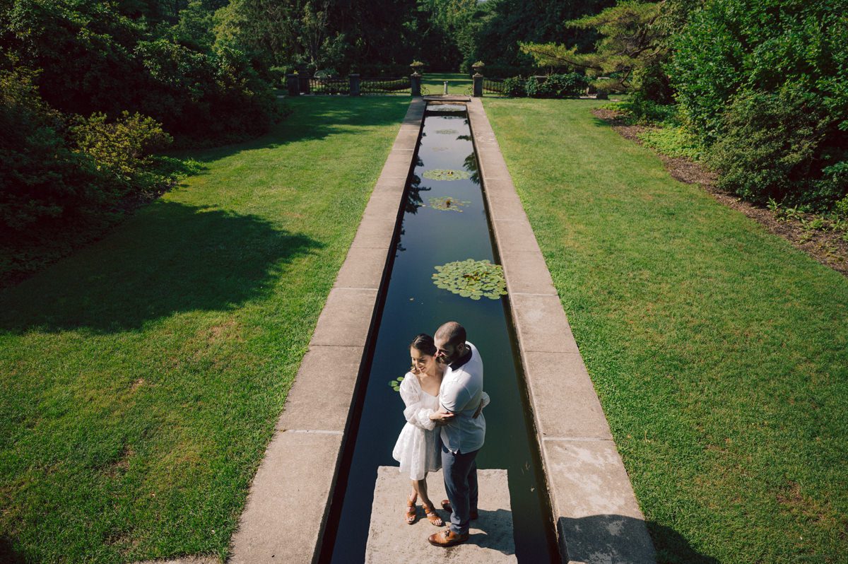 Ari and Kevin reached out with an intimate wedding plans and was pretty much ready to book me as soon as they got on the phone. Most intimate wedding couples opt out of engagement session but Ari knew she wanted an engagement session to celebrate their love before their intimate wedding in August. Ari and Kevin have very active lifestyle where they go climbing, hiking, running, etc...so by default they wanted an outdoor natury engagement session. We chose to meet at the botanical garden. Since we are in the middle of hot summer, we all agreed on early session when the park opened but even than 30mins into the engagement session it got real hot and humid. Ari not so much but Kevin was definitely started sweating. But Ari and Kevin along with their Corgi named Echo did amazing, we had so much fun as you can see from these photos of Ari, Kevin and Echo. Ari and Kevin's Botanical Garden engagement documented by by Karis | Hey Karis | Catskills, Hudson Valley NY elopement and wedding photographer | Brooklyn NY elopement and wedding photographer | Manhattan NY elopement and wedding photographer | Hey Karis is fun documentary wedding and elopement photographer.