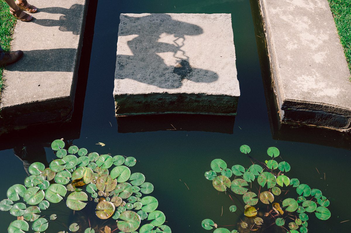 Ari and Kevin reached out with an intimate wedding plans and was pretty much ready to book me as soon as they got on the phone. Most intimate wedding couples opt out of engagement session but Ari knew she wanted an engagement session to celebrate their love before their intimate wedding in August. Ari and Kevin have very active lifestyle where they go climbing, hiking, running, etc...so by default they wanted an outdoor natury engagement session. We chose to meet at the botanical garden. Since we are in the middle of hot summer, we all agreed on early session when the park opened but even than 30mins into the engagement session it got real hot and humid. Ari not so much but Kevin was definitely started sweating. But Ari and Kevin along with their Corgi named Echo did amazing, we had so much fun as you can see from these photos of Ari, Kevin and Echo. Ari and Kevin's Botanical Garden engagement documented by by Karis | Hey Karis | Catskills, Hudson Valley NY elopement and wedding photographer | Brooklyn NY elopement and wedding photographer | Manhattan NY elopement and wedding photographer | Hey Karis is fun documentary wedding and elopement photographer.