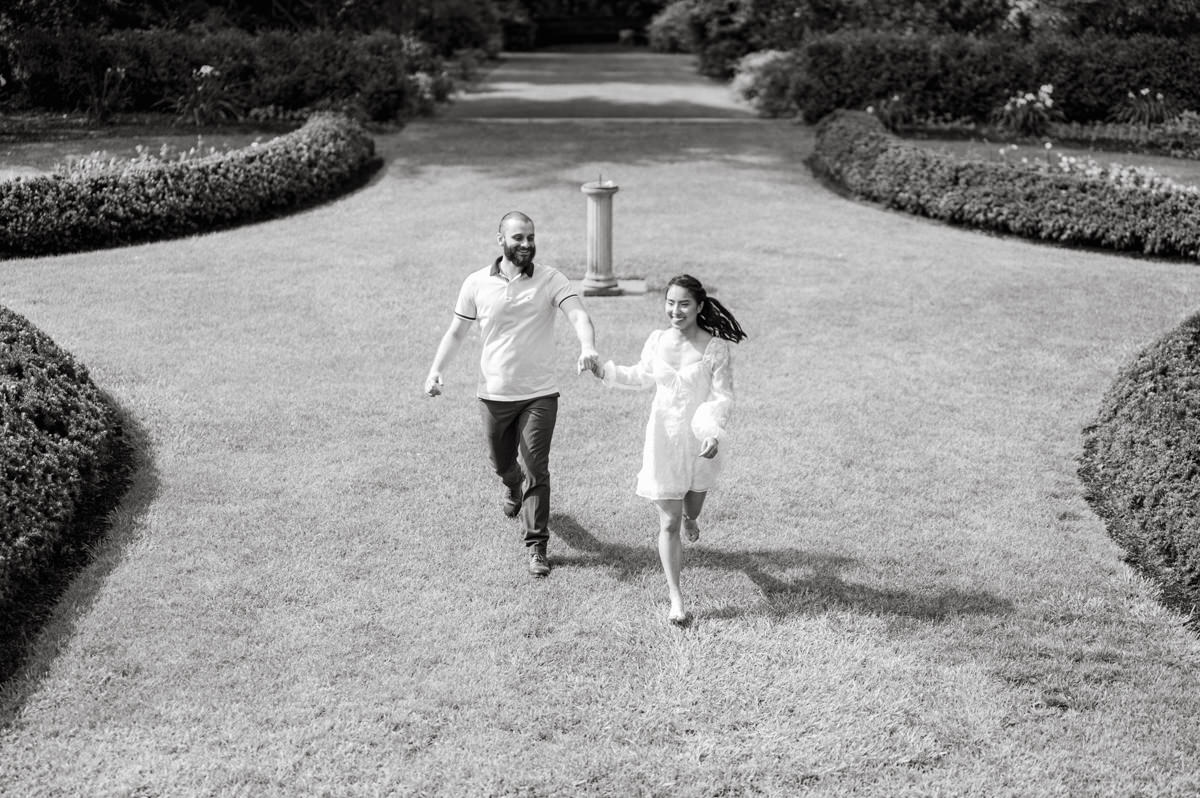 Ari and Kevin reached out with an intimate wedding plans and was pretty much ready to book me as soon as they got on the phone. Most intimate wedding couples opt out of engagement session but Ari knew she wanted an engagement session to celebrate their love before their intimate wedding in August. Ari and Kevin have very active lifestyle where they go climbing, hiking, running, etc...so by default they wanted an outdoor natury engagement session. We chose to meet at the botanical garden. Since we are in the middle of hot summer, we all agreed on early session when the park opened but even than 30mins into the engagement session it got real hot and humid. Ari not so much but Kevin was definitely started sweating. But Ari and Kevin along with their Corgi named Echo did amazing, we had so much fun as you can see from these photos of Ari, Kevin and Echo. Ari and Kevin's Botanical Garden engagement documented by by Karis | Hey Karis | Catskills, Hudson Valley NY elopement and wedding photographer | Brooklyn NY elopement and wedding photographer | Manhattan NY elopement and wedding photographer | Hey Karis is fun documentary wedding and elopement photographer.