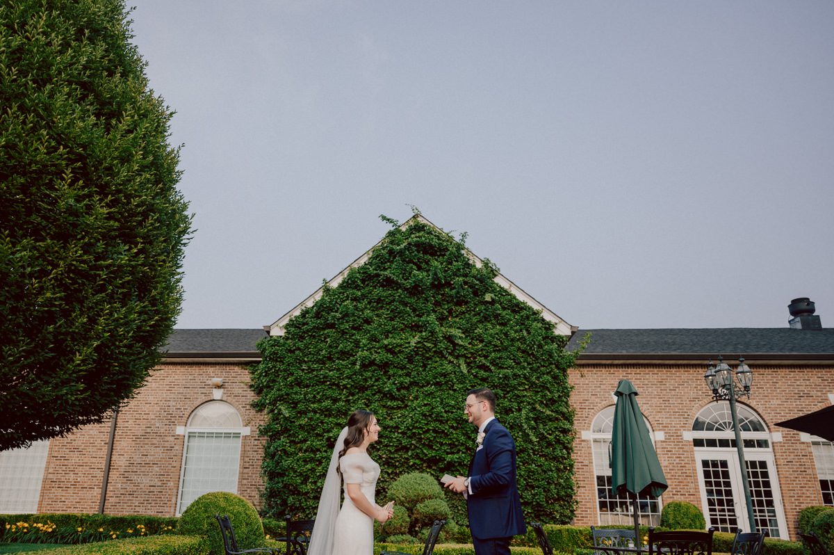Jackie and Nick the two New Yorkers wanted to get away from busy packed streets of NY and get married in NJ, The Rockleigh NJ. Jackie got ready at her parents house in Hasbrouck Heights in NJ where her mom and bridesmaids showered her with love while they got ready together for her wedding. Nick also got ready at his parents house in Park Ridge NJ. Jackie & Nick got into their limos and drove to the chapel Our Lady of mercy Church in Park Ridge NJ for their wedding ceremony. Jackie and Nick's beautiful wedding ceremony was over at Our Lady of Mercy Church followed by family photos at the church before heading over to The Rockleigh for their wedding reception and to party! The Rockleigh's garden's were beautiful with flowers and perfectly manicured bushes, trees and flowers. I did all of Jackie and Nick's wedding photos at the garden at The Rockleigh including extended family photos, bridal party photos as well as newly weds couple's photos. Then Jackie and Nick joined their guests at their cocktail hour to start their wedding party. Fun and beautiful wedding reception continued till midnight at The Rockleigh. Jackie and Nick's The Rockleigh NJ Wedding documented by by Karis | Hey Karis | Catskills, Hudson Valley NY elopement and wedding photographer | Brooklyn NY elopement and wedding photographer | Manhattan NY elopement and wedding photographer | Hey Karis is fun documentary wedding and elopement photographer.