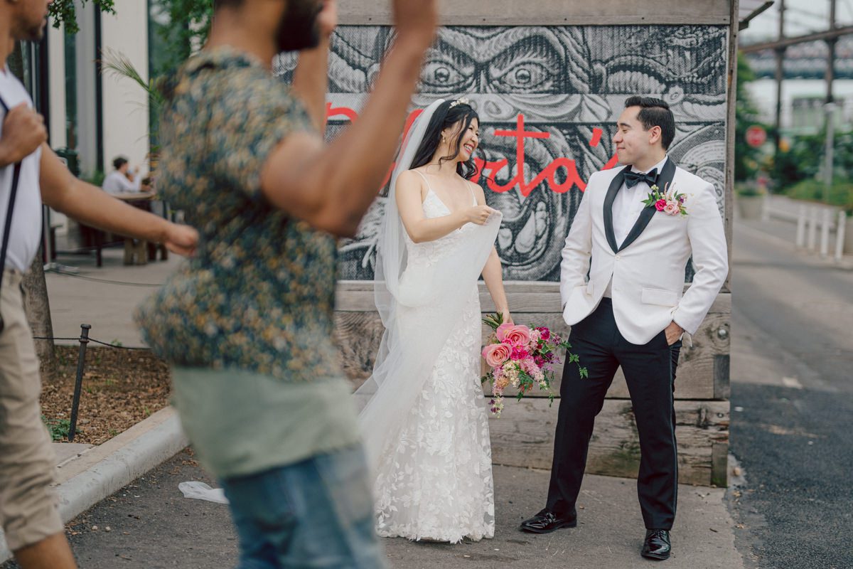 It's with immense joy that I share the unforgettable moments from Katherine and Omar's enchanting wedding day at The W Loft in Brooklyn, New York. Katherine and Omar saw each other for the first time rooftop of The W Loft with stunning backdrop of the city's skyline. The two spend some time talking and admiring each other during their first look, then as the moment finished and Katherine and Omar gave me the cue that they are ready to go to Domino Park (Williamsburg Bridge and the East River at the backdrop) was only around the corner from The W Loft for their wedding photos. We walked together with Katherine and Omar's bridal party to Domino Park, it was a typical hot NY summer on their wedding day and doing photos outside in the heat wasn't easy especially with so many people/crowd at Domino Park but we managed and even grabbed ice cream on the way back to The W Loft. Rooftop was busy setting up for Katherine and Omar's wedding ceremony with few guests already filing in the seats. Katherine and Omar's breathtaking wedding ceremony on The W Loft rooftop with Williamsburg Bridge to the side, the East River with city scape was a perfect backdrop for these New Yorkers to say their I do's. Then Katherine and Omar listened to sweet talks offered by their friends and family enjoyed their wedding reception. Katherine and Omar's The W Loft Brooklyn NY wedding documented by by Karis | Hey Karis | Catskills, Hudson Valley NY elopement and wedding photographer | Brooklyn NY elopement and wedding photographer | Manhattan NY elopement and wedding photographer | Hey Karis is fun documentary wedding and elopement photographer.