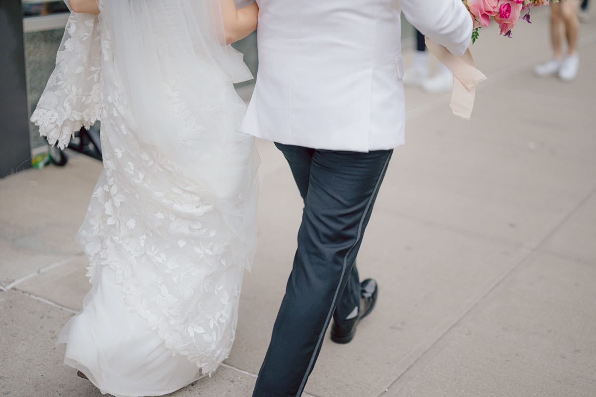 It's with immense joy that I share the unforgettable moments from Katherine and Omar's enchanting wedding day at The W Loft in Brooklyn, New York. Katherine and Omar saw each other for the first time rooftop of The W Loft with stunning backdrop of the city's skyline. The two spend some time talking and admiring each other during their first look, then as the moment finished and Katherine and Omar gave me the cue that they are ready to go to Domino Park (Williamsburg Bridge and the East River at the backdrop) was only around the corner from The W Loft for their wedding photos. We walked together with Katherine and Omar's bridal party to Domino Park, it was a typical hot NY summer on their wedding day and doing photos outside in the heat wasn't easy especially with so many people/crowd at Domino Park but we managed and even grabbed ice cream on the way back to The W Loft. Rooftop was busy setting up for Katherine and Omar's wedding ceremony with few guests already filing in the seats. Katherine and Omar's breathtaking wedding ceremony on The W Loft rooftop with Williamsburg Bridge to the side, the East River with city scape was a perfect backdrop for these New Yorkers to say their I do's. Then Katherine and Omar listened to sweet talks offered by their friends and family enjoyed their wedding reception. Katherine and Omar's The W Loft Brooklyn NY wedding documented by by Karis | Hey Karis | Catskills, Hudson Valley NY elopement and wedding photographer | Brooklyn NY elopement and wedding photographer | Manhattan NY elopement and wedding photographer | Hey Karis is fun documentary wedding and elopement photographer.