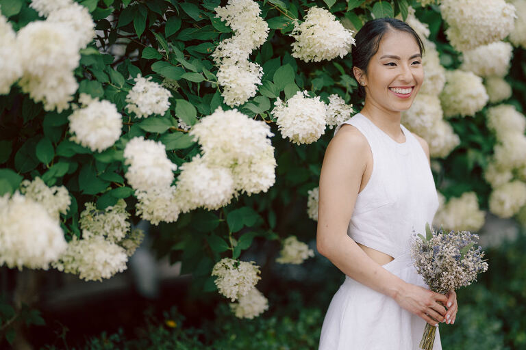 Ari and Kevin are big nature lovers, and they love the outdoors. For their intimate elopement they chose James A McFaul Environmental Center for their intimate wedding ceremony joined by their immediate family. Total of 10 people standing around Ari and Kevin surrounded by nature Ari & Kevin's sweetest wedding ceremony was held. Ari and Kevin looked at each other with the sweetest smiles it almost melted us. After the sweetest wedding ceremony at James A McFaul Environmental Center I took some wedding photos of Ari and Kevin then we left for Ari and Kevin's small and intimate dinner with family at Jockey Hollow Bar & Kitchen Morristown NJ. Morristown is such a beautiful town, and in front of Jockey Hollow Bar & Kitchen is such a picturesque backdrop with long water fountain, trees and flowers. So before Ari and Kevin sat down for their intimate dinner with family we walked around Morristown for quick photos. Then all 10 of them sat down in a private room at Jockey Hollow Bar & Kitchen to celebrate Ari and Kevin's union. Air and Kevin's James A McFaul Environmental Center and Jockey Hollow Bar & Kitchen Morristown NJ Elopement documented by by Karis | Hey Karis | Catskills, Hudson Valley NY elopement and wedding photographer | Brooklyn NY elopement and wedding photographer | Manhattan NY elopement and wedding photographer | Hey Karis is fun documentary wedding and elopement photographer.