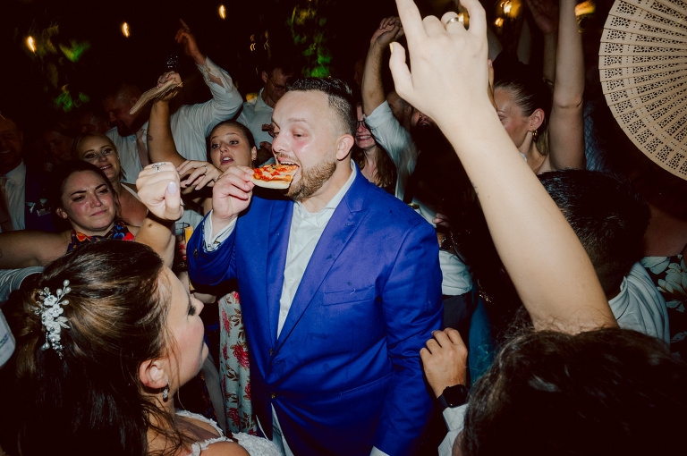 How do I explain the sincere and true feelings that Izzy and Brendan shared on their wedding day at one of the most magical place Arrow Park in Monroe NY. Izzy is Opera singer and Brendan is a Chef who owns his own restaurant called Circle in Newton, NJ got married at Arrow Park NY a month ago and it got real festive and wild real fast. But let's come back to the wild party in a bit and talk about their morning first. Izzy and Brendan both got ready onsite at Arrow Park, great thing about Arrow Park is that it has enough rooms to host all their bridal party and family. With all of Izzy and Brendan's loved ones onsite Izzy and Brendan's wedding prep was fun. No drama and no one running late, Izzy and Brendan's wedding prep went so smooth with everyone's cooperation! Izzy got into her dress with her mom and sister by her side, then we went down to the back steps for Izzy and Brendan's first look. Oh boy Brendan got super emotional for their first look, he couldn't even turn around to look at Izzy with all the happy emotions rushing to him. Izzy held his hand and they looked at each other. The two of them cried. Sharing such a beautiful first look Izzy and Brendan walked out to the front of Arrow Park for group and family photos. It was an August wedding so I kept everyone in the shade not too far, making it simple easy for group and family photos are important job to wedding photographer. After all the formal group photos were done, it was almost time for their wedding ceremony at the garden. Beautiful decor and floral arrangements were set up in the garden ready for Izzy and Brendan's wedding ceremony, guest started to walked down the long driveway and down the steps and found seats waited for the bride and groom to walk down the aisle. Brendan now standing in the front next to the priest, started tearing up as soon as he saw Izzy coming down the aisle escorted by her father. The two linked their eyes at each other and in the most loving way possible looked at each other through out the ceremony then sealed it with the first kiss as husband and wife. As calm and peaceful as Izzy and Brendan's wedding ceremony was, the two entered their reception each with (shaken) champagne bottles in their hands, everyone and anyone in Izzy and Brendan's way got sprayed with Champagne! They jumped, pouring Champagne into their friends mouth straight out of the bottle, then each drank some out of the bottle. Building the excitement in to their epic wedding party, Izzy and Brendan held each others hands and walked into the center of Arrow Park's courtyard and danced their first dance. Smoke and smell of freshly cooked dinner being prepared by Brendan's friends at Promises Kept Hudson Valley NY was filling the air, as first courses were being served. Happiest sound of plates, utensils and people chatting, Izzy and Brendan sat at their sweetheart table to enjoy their wedding dinner prepared by Promises Kept Hudson Valley NY. Then the evening got deeper and darker and vibe got stronger and crazier. Music got louder and everyone was in their element celebrating Izzy and Brendan on their wedding day. Izzy and Brendan's Arrow Park Monroe NY Wedding documented by by Karis | Hey Karis | Catskills, Hudson Valley NY elopement and wedding photographer | Brooklyn NY elopement and wedding photographer | Manhattan NY elopement and wedding photographer | Hey Karis is fun documentary wedding and elopement photographer.