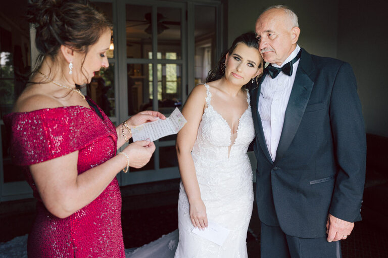 How do I explain the sincere and true feelings that Izzy and Brendan shared on their wedding day at one of the most magical place Arrow Park in Monroe NY. Izzy is Opera singer and Brendan is a Chef who owns his own restaurant called Circle in Newton, NJ got married at Arrow Park NY a month ago and it got real festive and wild real fast. But let's come back to the wild party in a bit and talk about their morning first. Izzy and Brendan both got ready onsite at Arrow Park, great thing about Arrow Park is that it has enough rooms to host all their bridal party and family. With all of Izzy and Brendan's loved ones onsite Izzy and Brendan's wedding prep was fun. No drama and no one running late, Izzy and Brendan's wedding prep went so smooth with everyone's cooperation! Izzy got into her dress with her mom and sister by her side, then we went down to the back steps for Izzy and Brendan's first look. Oh boy Brendan got super emotional for their first look, he couldn't even turn around to look at Izzy with all the happy emotions rushing to him. Izzy held his hand and they looked at each other. The two of them cried. Sharing such a beautiful first look Izzy and Brendan walked out to the front of Arrow Park for group and family photos. It was an August wedding so I kept everyone in the shade not too far, making it simple easy for group and family photos are important job to wedding photographer. After all the formal group photos were done, it was almost time for their wedding ceremony at the garden. Beautiful decor and floral arrangements were set up in the garden ready for Izzy and Brendan's wedding ceremony, guest started to walked down the long driveway and down the steps and found seats waited for the bride and groom to walk down the aisle. Brendan now standing in the front next to the priest, started tearing up as soon as he saw Izzy coming down the aisle escorted by her father. The two linked their eyes at each other and in the most loving way possible looked at each other through out the ceremony then sealed it with the first kiss as husband and wife. As calm and peaceful as Izzy and Brendan's wedding ceremony was, the two entered their reception each with (shaken) champagne bottles in their hands, everyone and anyone in Izzy and Brendan's way got sprayed with Champagne! They jumped, pouring Champagne into their friends mouth straight out of the bottle, then each drank some out of the bottle. Building the excitement in to their epic wedding party, Izzy and Brendan held each others hands and walked into the center of Arrow Park's courtyard and danced their first dance. Smoke and smell of freshly cooked dinner being prepared by Brendan's friends at Promises Kept Hudson Valley NY was filling the air, as first courses were being served. Happiest sound of plates, utensils and people chatting, Izzy and Brendan sat at their sweetheart table to enjoy their wedding dinner prepared by Promises Kept Hudson Valley NY. Then the evening got deeper and darker and vibe got stronger and crazier. Music got louder and everyone was in their element celebrating Izzy and Brendan on their wedding day. Izzy and Brendan's Arrow Park Monroe NY Wedding documented by by Karis | Hey Karis | Catskills, Hudson Valley NY elopement and wedding photographer | Brooklyn NY elopement and wedding photographer | Manhattan NY elopement and wedding photographer | Hey Karis is fun documentary wedding and elopement photographer.