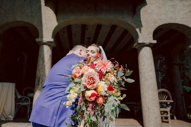 How do I explain the sincere and true feelings that Izzy and Brendan shared on their wedding day at one of the most magical place Arrow Park in Monroe NY. Izzy is Opera singer and Brendan is a Chef who owns his own restaurant called Circle in Newton, NJ got married at Arrow Park NY a month ago and it got real festive and wild real fast. But let's come back to the wild party in a bit and talk about their morning first. Izzy and Brendan both got ready onsite at Arrow Park, great thing about Arrow Park is that it has enough rooms to host all their bridal party and family. With all of Izzy and Brendan's loved ones onsite Izzy and Brendan's wedding prep was fun. No drama and no one running late, Izzy and Brendan's wedding prep went so smooth with everyone's cooperation! Izzy got into her dress with her mom and sister by her side, then we went down to the back steps for Izzy and Brendan's first look. Oh boy Brendan got super emotional for their first look, he couldn't even turn around to look at Izzy with all the happy emotions rushing to him. Izzy held his hand and they looked at each other. The two of them cried. Sharing such a beautiful first look Izzy and Brendan walked out to the front of Arrow Park for group and family photos. It was an August wedding so I kept everyone in the shade not too far, making it simple easy for group and family photos are important job to wedding photographer. After all the formal group photos were done, it was almost time for their wedding ceremony at the garden. Beautiful decor and floral arrangements were set up in the garden ready for Izzy and Brendan's wedding ceremony, guest started to walked down the long driveway and down the steps and found seats waited for the bride and groom to walk down the aisle. Brendan now standing in the front next to the priest, started tearing up as soon as he saw Izzy coming down the aisle escorted by her father. The two linked their eyes at each other and in the most loving way possible looked at each other through out the ceremony then sealed it with the first kiss as husband and wife. As calm and peaceful as Izzy and Brendan's wedding ceremony was, the two entered their reception each with (shaken) champagne bottles in their hands, everyone and anyone in Izzy and Brendan's way got sprayed with Champagne! They jumped, pouring Champagne into their friends mouth straight out of the bottle, then each drank some out of the bottle. Building the excitement in to their epic wedding party, Izzy and Brendan held each others hands and walked into the center of Arrow Park's courtyard and danced their first dance. Smoke and smell of freshly cooked dinner being prepared by Brendan's friends at Promises Kept Hudson Valley NY was filling the air, as first courses were being served. Happiest sound of plates, utensils and people chatting, Izzy and Brendan sat at their sweetheart table to enjoy their wedding dinner prepared by Promises Kept Hudson Valley NY. Then the evening got deeper and darker and vibe got stronger and crazier. Music got louder and everyone was in their element celebrating Izzy and Brendan on their wedding day. Izzy and Brendan's Arrow Park Monroe NY Wedding documented by by Karis | Hey Karis | Catskills, Hudson Valley NY elopement and wedding photographer | Brooklyn NY elopement and wedding photographer | Manhattan NY elopement and wedding photographer | Hey Karis is fun documentary wedding and elopement photographer.
