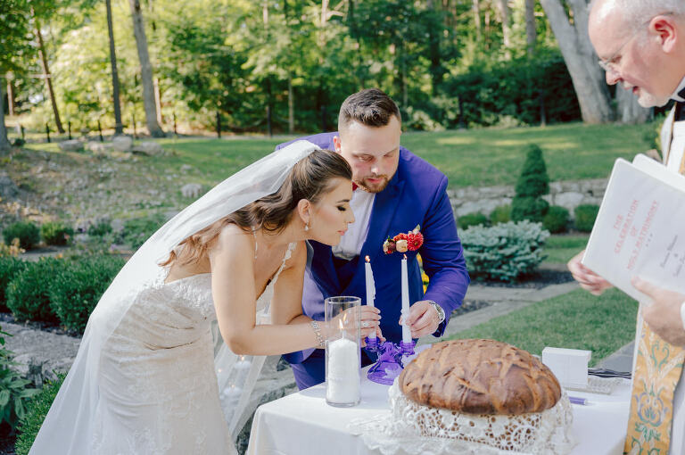 How do I explain the sincere and true feelings that Izzy and Brendan shared on their wedding day at one of the most magical place Arrow Park in Monroe NY. Izzy is Opera singer and Brendan is a Chef who owns his own restaurant called Circle in Newton, NJ got married at Arrow Park NY a month ago and it got real festive and wild real fast. But let's come back to the wild party in a bit and talk about their morning first. Izzy and Brendan both got ready onsite at Arrow Park, great thing about Arrow Park is that it has enough rooms to host all their bridal party and family. With all of Izzy and Brendan's loved ones onsite Izzy and Brendan's wedding prep was fun. No drama and no one running late, Izzy and Brendan's wedding prep went so smooth with everyone's cooperation! Izzy got into her dress with her mom and sister by her side, then we went down to the back steps for Izzy and Brendan's first look. Oh boy Brendan got super emotional for their first look, he couldn't even turn around to look at Izzy with all the happy emotions rushing to him. Izzy held his hand and they looked at each other. The two of them cried. Sharing such a beautiful first look Izzy and Brendan walked out to the front of Arrow Park for group and family photos. It was an August wedding so I kept everyone in the shade not too far, making it simple easy for group and family photos are important job to wedding photographer. After all the formal group photos were done, it was almost time for their wedding ceremony at the garden. Beautiful decor and floral arrangements were set up in the garden ready for Izzy and Brendan's wedding ceremony, guest started to walked down the long driveway and down the steps and found seats waited for the bride and groom to walk down the aisle. Brendan now standing in the front next to the priest, started tearing up as soon as he saw Izzy coming down the aisle escorted by her father. The two linked their eyes at each other and in the most loving way possible looked at each other through out the ceremony then sealed it with the first kiss as husband and wife. As calm and peaceful as Izzy and Brendan's wedding ceremony was, the two entered their reception each with (shaken) champagne bottles in their hands, everyone and anyone in Izzy and Brendan's way got sprayed with Champagne! They jumped, pouring Champagne into their friends mouth straight out of the bottle, then each drank some out of the bottle. Building the excitement in to their epic wedding party, Izzy and Brendan held each others hands and walked into the center of Arrow Park's courtyard and danced their first dance. Smoke and smell of freshly cooked dinner being prepared by Brendan's friends at Promises Kept Hudson Valley NY was filling the air, as first courses were being served. Happiest sound of plates, utensils and people chatting, Izzy and Brendan sat at their sweetheart table to enjoy their wedding dinner prepared by Promises Kept Hudson Valley NY. Then the evening got deeper and darker and vibe got stronger and crazier. Music got louder and everyone was in their element celebrating Izzy and Brendan on their wedding day. Izzy and Brendan's Arrow Park Monroe NY Wedding documented by by Karis | Hey Karis | Catskills, Hudson Valley NY elopement and wedding photographer | Brooklyn NY elopement and wedding photographer | Manhattan NY elopement and wedding photographer | Hey Karis is fun documentary wedding and elopement photographer.