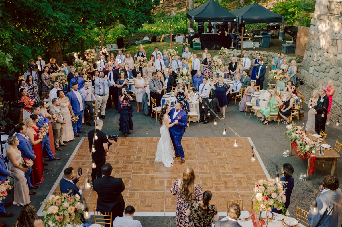 How do I explain the sincere and true feelings that Izzy and Brendan shared on their wedding day at one of the most magical place Arrow Park in Monroe NY. Izzy is Opera singer and Brendan is a Chef who owns his own restaurant called Circle in Newton, NJ got married at Arrow Park NY a month ago and it got real festive and wild real fast. But let's come back to the wild party in a bit and talk about their morning first. Izzy and Brendan both got ready onsite at Arrow Park, great thing about Arrow Park is that it has enough rooms to host all their bridal party and family. With all of Izzy and Brendan's loved ones onsite Izzy and Brendan's wedding prep was fun. No drama and no one running late, Izzy and Brendan's wedding prep went so smooth with everyone's cooperation! Izzy got into her dress with her mom and sister by her side, then we went down to the back steps for Izzy and Brendan's first look. Oh boy Brendan got super emotional for their first look, he couldn't even turn around to look at Izzy with all the happy emotions rushing to him. Izzy held his hand and they looked at each other. The two of them cried. Sharing such a beautiful first look Izzy and Brendan walked out to the front of Arrow Park for group and family photos. It was an August wedding so I kept everyone in the shade not too far, making it simple easy for group and family photos are important job to wedding photographer. After all the formal group photos were done, it was almost time for their wedding ceremony at the garden. Beautiful decor and floral arrangements were set up in the garden ready for Izzy and Brendan's wedding ceremony, guest started to walked down the long driveway and down the steps and found seats waited for the bride and groom to walk down the aisle. Brendan now standing in the front next to the priest, started tearing up as soon as he saw Izzy coming down the aisle escorted by her father. The two linked their eyes at each other and in the most loving way possible looked at each other through out the ceremony then sealed it with the first kiss as husband and wife. As calm and peaceful as Izzy and Brendan's wedding ceremony was, the two entered their reception each with (shaken) champagne bottles in their hands, everyone and anyone in Izzy and Brendan's way got sprayed with Champagne! They jumped, pouring Champagne into their friends mouth straight out of the bottle, then each drank some out of the bottle. Building the excitement in to their epic wedding party, Izzy and Brendan held each others hands and walked into the center of Arrow Park's courtyard and danced their first dance. Smoke and smell of freshly cooked dinner being prepared by Brendan's friends at Promises Kept Hudson Valley NY was filling the air, as first courses were being served. Happiest sound of plates, utensils and people chatting, Izzy and Brendan sat at their sweetheart table to enjoy their wedding dinner prepared by Promises Kept Hudson Valley NY. Then the evening got deeper and darker and vibe got stronger and crazier. Music got louder and everyone was in their element celebrating Izzy and Brendan on their wedding day. Izzy and Brendan's Arrow Park Monroe NY Wedding documented by by Karis | Hey Karis | Catskills, Hudson Valley NY elopement and wedding photographer | Brooklyn NY elopement and wedding photographer | Manhattan NY elopement and wedding photographer | Hey Karis is fun documentary wedding and elopement photographer.