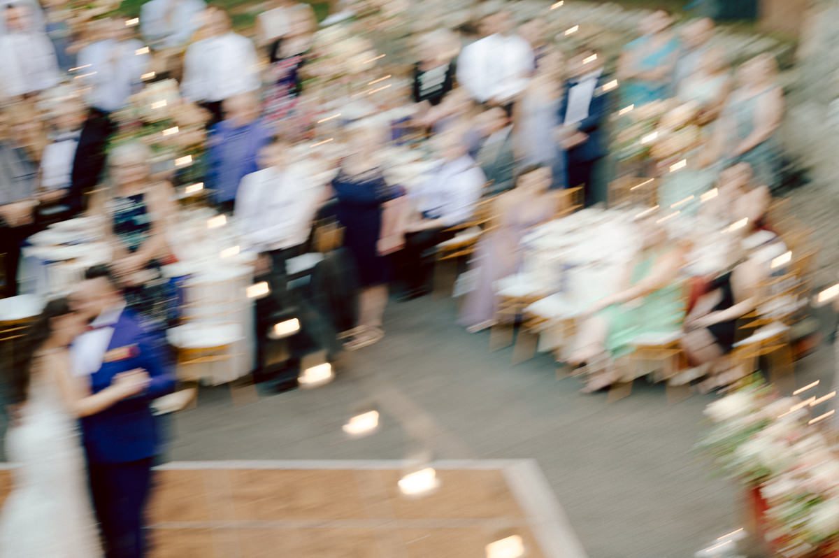 How do I explain the sincere and true feelings that Izzy and Brendan shared on their wedding day at one of the most magical place Arrow Park in Monroe NY. Izzy is Opera singer and Brendan is a Chef who owns his own restaurant called Circle in Newton, NJ got married at Arrow Park NY a month ago and it got real festive and wild real fast. But let's come back to the wild party in a bit and talk about their morning first. Izzy and Brendan both got ready onsite at Arrow Park, great thing about Arrow Park is that it has enough rooms to host all their bridal party and family. With all of Izzy and Brendan's loved ones onsite Izzy and Brendan's wedding prep was fun. No drama and no one running late, Izzy and Brendan's wedding prep went so smooth with everyone's cooperation! Izzy got into her dress with her mom and sister by her side, then we went down to the back steps for Izzy and Brendan's first look. Oh boy Brendan got super emotional for their first look, he couldn't even turn around to look at Izzy with all the happy emotions rushing to him. Izzy held his hand and they looked at each other. The two of them cried. Sharing such a beautiful first look Izzy and Brendan walked out to the front of Arrow Park for group and family photos. It was an August wedding so I kept everyone in the shade not too far, making it simple easy for group and family photos are important job to wedding photographer. After all the formal group photos were done, it was almost time for their wedding ceremony at the garden. Beautiful decor and floral arrangements were set up in the garden ready for Izzy and Brendan's wedding ceremony, guest started to walked down the long driveway and down the steps and found seats waited for the bride and groom to walk down the aisle. Brendan now standing in the front next to the priest, started tearing up as soon as he saw Izzy coming down the aisle escorted by her father. The two linked their eyes at each other and in the most loving way possible looked at each other through out the ceremony then sealed it with the first kiss as husband and wife. As calm and peaceful as Izzy and Brendan's wedding ceremony was, the two entered their reception each with (shaken) champagne bottles in their hands, everyone and anyone in Izzy and Brendan's way got sprayed with Champagne! They jumped, pouring Champagne into their friends mouth straight out of the bottle, then each drank some out of the bottle. Building the excitement in to their epic wedding party, Izzy and Brendan held each others hands and walked into the center of Arrow Park's courtyard and danced their first dance. Smoke and smell of freshly cooked dinner being prepared by Brendan's friends at Promises Kept Hudson Valley NY was filling the air, as first courses were being served. Happiest sound of plates, utensils and people chatting, Izzy and Brendan sat at their sweetheart table to enjoy their wedding dinner prepared by Promises Kept Hudson Valley NY. Then the evening got deeper and darker and vibe got stronger and crazier. Music got louder and everyone was in their element celebrating Izzy and Brendan on their wedding day. Izzy and Brendan's Arrow Park Monroe NY Wedding documented by by Karis | Hey Karis | Catskills, Hudson Valley NY elopement and wedding photographer | Brooklyn NY elopement and wedding photographer | Manhattan NY elopement and wedding photographer | Hey Karis is fun documentary wedding and elopement photographer.