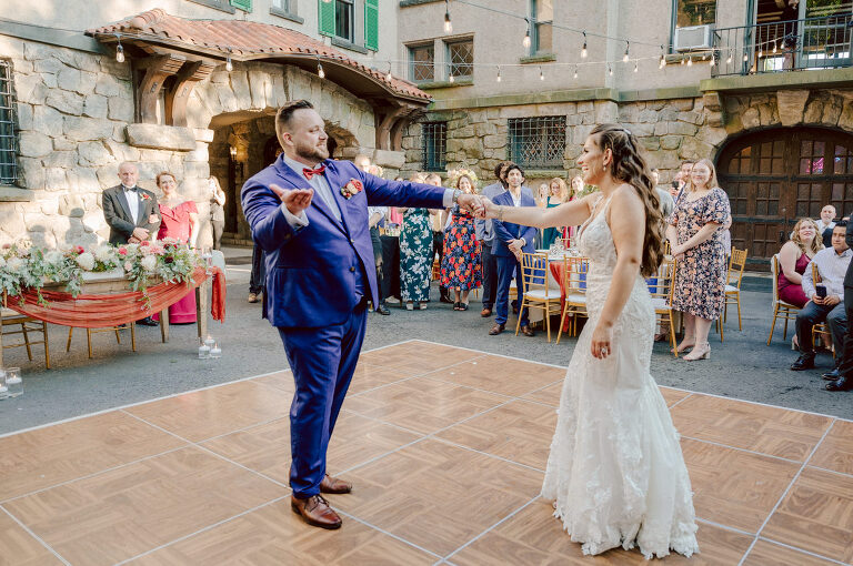 How do I explain the sincere and true feelings that Izzy and Brendan shared on their wedding day at one of the most magical place Arrow Park in Monroe NY. Izzy is Opera singer and Brendan is a Chef who owns his own restaurant called Circle in Newton, NJ got married at Arrow Park NY a month ago and it got real festive and wild real fast. But let's come back to the wild party in a bit and talk about their morning first. Izzy and Brendan both got ready onsite at Arrow Park, great thing about Arrow Park is that it has enough rooms to host all their bridal party and family. With all of Izzy and Brendan's loved ones onsite Izzy and Brendan's wedding prep was fun. No drama and no one running late, Izzy and Brendan's wedding prep went so smooth with everyone's cooperation! Izzy got into her dress with her mom and sister by her side, then we went down to the back steps for Izzy and Brendan's first look. Oh boy Brendan got super emotional for their first look, he couldn't even turn around to look at Izzy with all the happy emotions rushing to him. Izzy held his hand and they looked at each other. The two of them cried. Sharing such a beautiful first look Izzy and Brendan walked out to the front of Arrow Park for group and family photos. It was an August wedding so I kept everyone in the shade not too far, making it simple easy for group and family photos are important job to wedding photographer. After all the formal group photos were done, it was almost time for their wedding ceremony at the garden. Beautiful decor and floral arrangements were set up in the garden ready for Izzy and Brendan's wedding ceremony, guest started to walked down the long driveway and down the steps and found seats waited for the bride and groom to walk down the aisle. Brendan now standing in the front next to the priest, started tearing up as soon as he saw Izzy coming down the aisle escorted by her father. The two linked their eyes at each other and in the most loving way possible looked at each other through out the ceremony then sealed it with the first kiss as husband and wife. As calm and peaceful as Izzy and Brendan's wedding ceremony was, the two entered their reception each with (shaken) champagne bottles in their hands, everyone and anyone in Izzy and Brendan's way got sprayed with Champagne! They jumped, pouring Champagne into their friends mouth straight out of the bottle, then each drank some out of the bottle. Building the excitement in to their epic wedding party, Izzy and Brendan held each others hands and walked into the center of Arrow Park's courtyard and danced their first dance. Smoke and smell of freshly cooked dinner being prepared by Brendan's friends at Promises Kept Hudson Valley NY was filling the air, as first courses were being served. Happiest sound of plates, utensils and people chatting, Izzy and Brendan sat at their sweetheart table to enjoy their wedding dinner prepared by Promises Kept Hudson Valley NY. Then the evening got deeper and darker and vibe got stronger and crazier. Music got louder and everyone was in their element celebrating Izzy and Brendan on their wedding day. Izzy and Brendan's Arrow Park Monroe NY Wedding documented by by Karis | Hey Karis | Catskills, Hudson Valley NY elopement and wedding photographer | Brooklyn NY elopement and wedding photographer | Manhattan NY elopement and wedding photographer | Hey Karis is fun documentary wedding and elopement photographer.