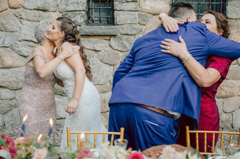 How do I explain the sincere and true feelings that Izzy and Brendan shared on their wedding day at one of the most magical place Arrow Park in Monroe NY. Izzy is Opera singer and Brendan is a Chef who owns his own restaurant called Circle in Newton, NJ got married at Arrow Park NY a month ago and it got real festive and wild real fast. But let's come back to the wild party in a bit and talk about their morning first. Izzy and Brendan both got ready onsite at Arrow Park, great thing about Arrow Park is that it has enough rooms to host all their bridal party and family. With all of Izzy and Brendan's loved ones onsite Izzy and Brendan's wedding prep was fun. No drama and no one running late, Izzy and Brendan's wedding prep went so smooth with everyone's cooperation! Izzy got into her dress with her mom and sister by her side, then we went down to the back steps for Izzy and Brendan's first look. Oh boy Brendan got super emotional for their first look, he couldn't even turn around to look at Izzy with all the happy emotions rushing to him. Izzy held his hand and they looked at each other. The two of them cried. Sharing such a beautiful first look Izzy and Brendan walked out to the front of Arrow Park for group and family photos. It was an August wedding so I kept everyone in the shade not too far, making it simple easy for group and family photos are important job to wedding photographer. After all the formal group photos were done, it was almost time for their wedding ceremony at the garden. Beautiful decor and floral arrangements were set up in the garden ready for Izzy and Brendan's wedding ceremony, guest started to walked down the long driveway and down the steps and found seats waited for the bride and groom to walk down the aisle. Brendan now standing in the front next to the priest, started tearing up as soon as he saw Izzy coming down the aisle escorted by her father. The two linked their eyes at each other and in the most loving way possible looked at each other through out the ceremony then sealed it with the first kiss as husband and wife. As calm and peaceful as Izzy and Brendan's wedding ceremony was, the two entered their reception each with (shaken) champagne bottles in their hands, everyone and anyone in Izzy and Brendan's way got sprayed with Champagne! They jumped, pouring Champagne into their friends mouth straight out of the bottle, then each drank some out of the bottle. Building the excitement in to their epic wedding party, Izzy and Brendan held each others hands and walked into the center of Arrow Park's courtyard and danced their first dance. Smoke and smell of freshly cooked dinner being prepared by Brendan's friends at Promises Kept Hudson Valley NY was filling the air, as first courses were being served. Happiest sound of plates, utensils and people chatting, Izzy and Brendan sat at their sweetheart table to enjoy their wedding dinner prepared by Promises Kept Hudson Valley NY. Then the evening got deeper and darker and vibe got stronger and crazier. Music got louder and everyone was in their element celebrating Izzy and Brendan on their wedding day. Izzy and Brendan's Arrow Park Monroe NY Wedding documented by by Karis | Hey Karis | Catskills, Hudson Valley NY elopement and wedding photographer | Brooklyn NY elopement and wedding photographer | Manhattan NY elopement and wedding photographer | Hey Karis is fun documentary wedding and elopement photographer.