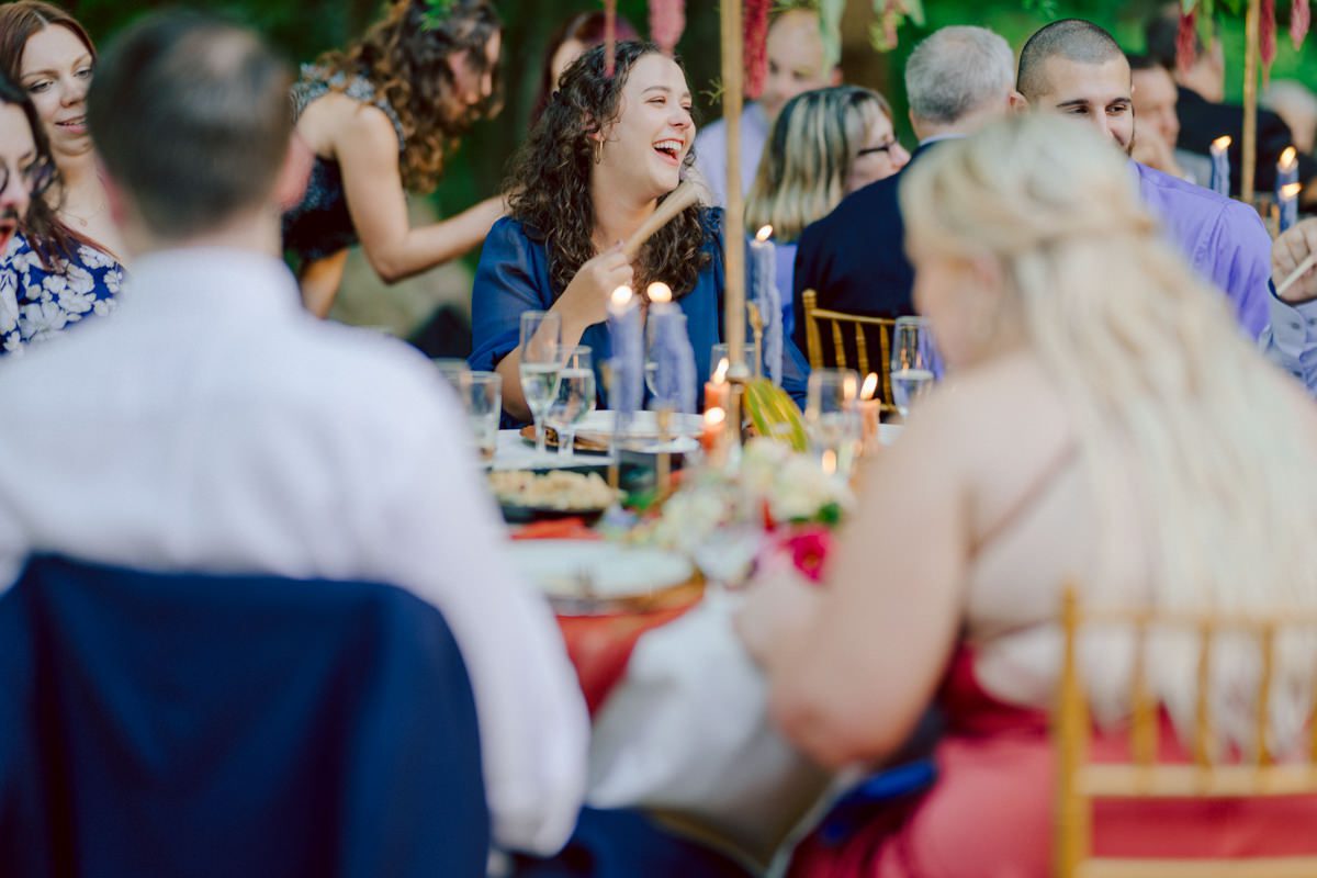 How do I explain the sincere and true feelings that Izzy and Brendan shared on their wedding day at one of the most magical place Arrow Park in Monroe NY. Izzy is Opera singer and Brendan is a Chef who owns his own restaurant called Circle in Newton, NJ got married at Arrow Park NY a month ago and it got real festive and wild real fast. But let's come back to the wild party in a bit and talk about their morning first. Izzy and Brendan both got ready onsite at Arrow Park, great thing about Arrow Park is that it has enough rooms to host all their bridal party and family. With all of Izzy and Brendan's loved ones onsite Izzy and Brendan's wedding prep was fun. No drama and no one running late, Izzy and Brendan's wedding prep went so smooth with everyone's cooperation! Izzy got into her dress with her mom and sister by her side, then we went down to the back steps for Izzy and Brendan's first look. Oh boy Brendan got super emotional for their first look, he couldn't even turn around to look at Izzy with all the happy emotions rushing to him. Izzy held his hand and they looked at each other. The two of them cried. Sharing such a beautiful first look Izzy and Brendan walked out to the front of Arrow Park for group and family photos. It was an August wedding so I kept everyone in the shade not too far, making it simple easy for group and family photos are important job to wedding photographer. After all the formal group photos were done, it was almost time for their wedding ceremony at the garden. Beautiful decor and floral arrangements were set up in the garden ready for Izzy and Brendan's wedding ceremony, guest started to walked down the long driveway and down the steps and found seats waited for the bride and groom to walk down the aisle. Brendan now standing in the front next to the priest, started tearing up as soon as he saw Izzy coming down the aisle escorted by her father. The two linked their eyes at each other and in the most loving way possible looked at each other through out the ceremony then sealed it with the first kiss as husband and wife. As calm and peaceful as Izzy and Brendan's wedding ceremony was, the two entered their reception each with (shaken) champagne bottles in their hands, everyone and anyone in Izzy and Brendan's way got sprayed with Champagne! They jumped, pouring Champagne into their friends mouth straight out of the bottle, then each drank some out of the bottle. Building the excitement in to their epic wedding party, Izzy and Brendan held each others hands and walked into the center of Arrow Park's courtyard and danced their first dance. Smoke and smell of freshly cooked dinner being prepared by Brendan's friends at Promises Kept Hudson Valley NY was filling the air, as first courses were being served. Happiest sound of plates, utensils and people chatting, Izzy and Brendan sat at their sweetheart table to enjoy their wedding dinner prepared by Promises Kept Hudson Valley NY. Then the evening got deeper and darker and vibe got stronger and crazier. Music got louder and everyone was in their element celebrating Izzy and Brendan on their wedding day. Izzy and Brendan's Arrow Park Monroe NY Wedding documented by by Karis | Hey Karis | Catskills, Hudson Valley NY elopement and wedding photographer | Brooklyn NY elopement and wedding photographer | Manhattan NY elopement and wedding photographer | Hey Karis is fun documentary wedding and elopement photographer.