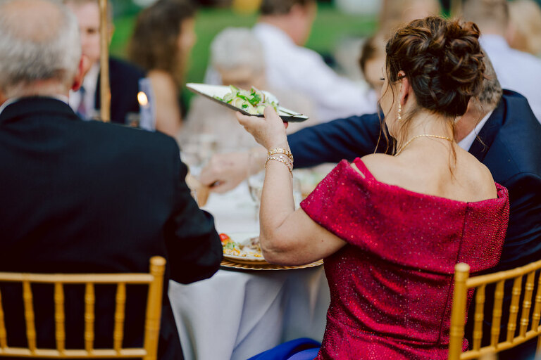 How do I explain the sincere and true feelings that Izzy and Brendan shared on their wedding day at one of the most magical place Arrow Park in Monroe NY. Izzy is Opera singer and Brendan is a Chef who owns his own restaurant called Circle in Newton, NJ got married at Arrow Park NY a month ago and it got real festive and wild real fast. But let's come back to the wild party in a bit and talk about their morning first. Izzy and Brendan both got ready onsite at Arrow Park, great thing about Arrow Park is that it has enough rooms to host all their bridal party and family. With all of Izzy and Brendan's loved ones onsite Izzy and Brendan's wedding prep was fun. No drama and no one running late, Izzy and Brendan's wedding prep went so smooth with everyone's cooperation! Izzy got into her dress with her mom and sister by her side, then we went down to the back steps for Izzy and Brendan's first look. Oh boy Brendan got super emotional for their first look, he couldn't even turn around to look at Izzy with all the happy emotions rushing to him. Izzy held his hand and they looked at each other. The two of them cried. Sharing such a beautiful first look Izzy and Brendan walked out to the front of Arrow Park for group and family photos. It was an August wedding so I kept everyone in the shade not too far, making it simple easy for group and family photos are important job to wedding photographer. After all the formal group photos were done, it was almost time for their wedding ceremony at the garden. Beautiful decor and floral arrangements were set up in the garden ready for Izzy and Brendan's wedding ceremony, guest started to walked down the long driveway and down the steps and found seats waited for the bride and groom to walk down the aisle. Brendan now standing in the front next to the priest, started tearing up as soon as he saw Izzy coming down the aisle escorted by her father. The two linked their eyes at each other and in the most loving way possible looked at each other through out the ceremony then sealed it with the first kiss as husband and wife. As calm and peaceful as Izzy and Brendan's wedding ceremony was, the two entered their reception each with (shaken) champagne bottles in their hands, everyone and anyone in Izzy and Brendan's way got sprayed with Champagne! They jumped, pouring Champagne into their friends mouth straight out of the bottle, then each drank some out of the bottle. Building the excitement in to their epic wedding party, Izzy and Brendan held each others hands and walked into the center of Arrow Park's courtyard and danced their first dance. Smoke and smell of freshly cooked dinner being prepared by Brendan's friends at Promises Kept Hudson Valley NY was filling the air, as first courses were being served. Happiest sound of plates, utensils and people chatting, Izzy and Brendan sat at their sweetheart table to enjoy their wedding dinner prepared by Promises Kept Hudson Valley NY. Then the evening got deeper and darker and vibe got stronger and crazier. Music got louder and everyone was in their element celebrating Izzy and Brendan on their wedding day. Izzy and Brendan's Arrow Park Monroe NY Wedding documented by by Karis | Hey Karis | Catskills, Hudson Valley NY elopement and wedding photographer | Brooklyn NY elopement and wedding photographer | Manhattan NY elopement and wedding photographer | Hey Karis is fun documentary wedding and elopement photographer.