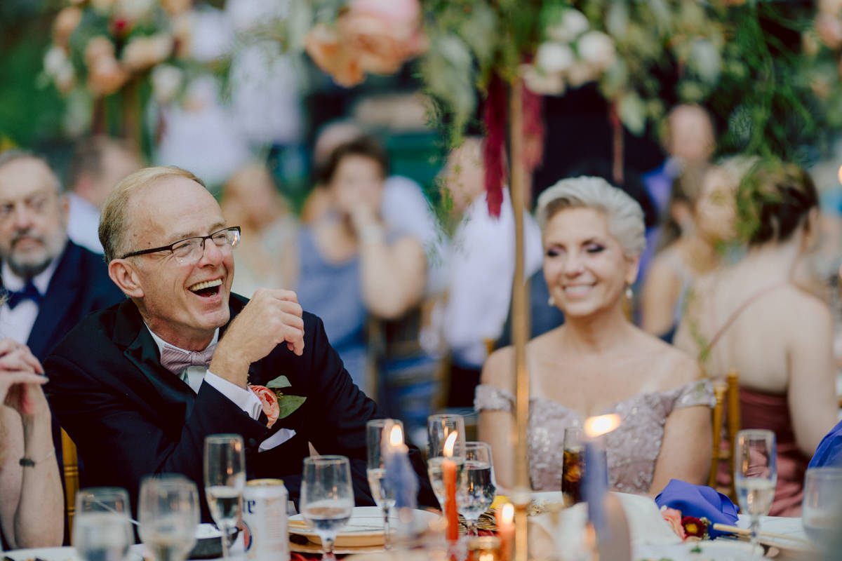 How do I explain the sincere and true feelings that Izzy and Brendan shared on their wedding day at one of the most magical place Arrow Park in Monroe NY. Izzy is Opera singer and Brendan is a Chef who owns his own restaurant called Circle in Newton, NJ got married at Arrow Park NY a month ago and it got real festive and wild real fast. But let's come back to the wild party in a bit and talk about their morning first. Izzy and Brendan both got ready onsite at Arrow Park, great thing about Arrow Park is that it has enough rooms to host all their bridal party and family. With all of Izzy and Brendan's loved ones onsite Izzy and Brendan's wedding prep was fun. No drama and no one running late, Izzy and Brendan's wedding prep went so smooth with everyone's cooperation! Izzy got into her dress with her mom and sister by her side, then we went down to the back steps for Izzy and Brendan's first look. Oh boy Brendan got super emotional for their first look, he couldn't even turn around to look at Izzy with all the happy emotions rushing to him. Izzy held his hand and they looked at each other. The two of them cried. Sharing such a beautiful first look Izzy and Brendan walked out to the front of Arrow Park for group and family photos. It was an August wedding so I kept everyone in the shade not too far, making it simple easy for group and family photos are important job to wedding photographer. After all the formal group photos were done, it was almost time for their wedding ceremony at the garden. Beautiful decor and floral arrangements were set up in the garden ready for Izzy and Brendan's wedding ceremony, guest started to walked down the long driveway and down the steps and found seats waited for the bride and groom to walk down the aisle. Brendan now standing in the front next to the priest, started tearing up as soon as he saw Izzy coming down the aisle escorted by her father. The two linked their eyes at each other and in the most loving way possible looked at each other through out the ceremony then sealed it with the first kiss as husband and wife. As calm and peaceful as Izzy and Brendan's wedding ceremony was, the two entered their reception each with (shaken) champagne bottles in their hands, everyone and anyone in Izzy and Brendan's way got sprayed with Champagne! They jumped, pouring Champagne into their friends mouth straight out of the bottle, then each drank some out of the bottle. Building the excitement in to their epic wedding party, Izzy and Brendan held each others hands and walked into the center of Arrow Park's courtyard and danced their first dance. Smoke and smell of freshly cooked dinner being prepared by Brendan's friends at Promises Kept Hudson Valley NY was filling the air, as first courses were being served. Happiest sound of plates, utensils and people chatting, Izzy and Brendan sat at their sweetheart table to enjoy their wedding dinner prepared by Promises Kept Hudson Valley NY. Then the evening got deeper and darker and vibe got stronger and crazier. Music got louder and everyone was in their element celebrating Izzy and Brendan on their wedding day. Izzy and Brendan's Arrow Park Monroe NY Wedding documented by by Karis | Hey Karis | Catskills, Hudson Valley NY elopement and wedding photographer | Brooklyn NY elopement and wedding photographer | Manhattan NY elopement and wedding photographer | Hey Karis is fun documentary wedding and elopement photographer.