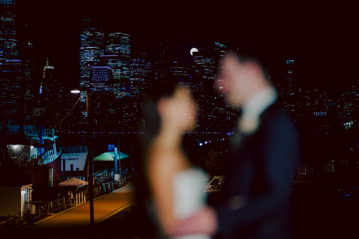 On September 1, 2023 Renee and Sam got married at Maritime Parc located in the center of Liberty State Park where you can get the best view of NYC skyline. Renee and Sam couldn't have asked for a better day, weather in October it was sunny, warm and gorgeous. Renee got ready at her parents' house in Paramus NJ where Renee intimately got ready for her wedding with her parents, two sisters and best friends. Renee's hair and makeup was done by Anna Posokhina from Bridal Squad. Once Renee was all glammed out by Anna Posokhina with help of her mother and two sisters walked into her Justin Alexander wedding dress. With final spray of Jo Malone perfume Renee walked out of her parents' house with her bridesmaids and stepped into her party bus. At the same time Sam was getting ready at Renee's sister's house in Hawthorne NJ with his family and groomsmen. Then Renee and Sam saw each other for the first time down the aisle at Our Lady of the Visitation in Paramus NJ. As soon as Sam saw Renee standing by the entrance of the church started crying. With plenty time for photo we arrived at Liberty State Park where Renee only wanted photos with NYC backdrop even it was staring at the bright sun and squinty eyes, i don't blame her because the view is spectacular and who wouldn't want photos with this gorgeous backdrop of NYC. Cocktail hour started and guests started fill the stairs to third floor of Maritime Parc. Renee and Sam's amazing wedding day at Maritime Parc continued with music provided by live band "The Hook Club" where they set the mood for all night of dancing. And we ended the evening with most amazing NYC skyline with Super moon rising above NYC. Renee and Sam's Maritime Park Jersey City NJ wedding photographed and documented by by Karis | Hey Karis | Catskills, Hudson Valley NY elopement and wedding photographer | Brooklyn NY elopement and wedding photographer | Manhattan NY elopement and wedding photographer | Hey Karis is fun documentary wedding and elopement photographer.