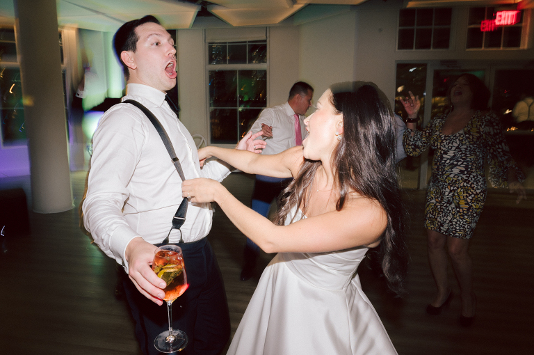 On September 1, 2023 Renee and Sam got married at Maritime Parc located in the center of Liberty State Park where you can get the best view of NYC skyline. Renee and Sam couldn't have asked for a better day, weather in October it was sunny, warm and gorgeous. Renee got ready at her parents' house in Paramus NJ where Renee intimately got ready for her wedding with her parents, two sisters and best friends. Renee's hair and makeup was done by Anna Posokhina from Bridal Squad. Once Renee was all glammed out by Anna Posokhina with help of her mother and two sisters walked into her Justin Alexander wedding dress. With final spray of Jo Malone perfume Renee walked out of her parents' house with her bridesmaids and stepped into her party bus. At the same time Sam was getting ready at Renee's sister's house in Hawthorne NJ with his family and groomsmen. Then Renee and Sam saw each other for the first time down the aisle at Our Lady of the Visitation in Paramus NJ. As soon as Sam saw Renee standing by the entrance of the church started crying. With plenty time for photo we arrived at Liberty State Park where Renee only wanted photos with NYC backdrop even it was staring at the bright sun and squinty eyes, i don't blame her because the view is spectacular and who wouldn't want photos with this gorgeous backdrop of NYC. Cocktail hour started and guests started fill the stairs to third floor of Maritime Parc. Renee and Sam's amazing wedding day at Maritime Parc continued with music provided by live band "The Hook Club" where they set the mood for all night of dancing. And we ended the evening with most amazing NYC skyline with Super moon rising above NYC. Renee and Sam's Maritime Park Jersey City NJ wedding photographed and documented by by Karis | Hey Karis | Catskills, Hudson Valley NY elopement and wedding photographer | Brooklyn NY elopement and wedding photographer | Manhattan NY elopement and wedding photographer | Hey Karis is fun documentary wedding and elopement photographer.
