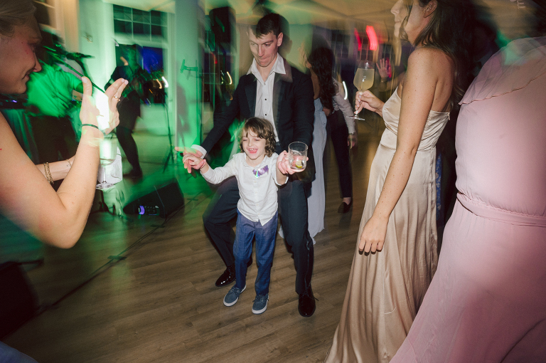 On September 1, 2023 Renee and Sam got married at Maritime Parc located in the center of Liberty State Park where you can get the best view of NYC skyline. Renee and Sam couldn't have asked for a better day, weather in October it was sunny, warm and gorgeous. Renee got ready at her parents' house in Paramus NJ where Renee intimately got ready for her wedding with her parents, two sisters and best friends. Renee's hair and makeup was done by Anna Posokhina from Bridal Squad. Once Renee was all glammed out by Anna Posokhina with help of her mother and two sisters walked into her Justin Alexander wedding dress. With final spray of Jo Malone perfume Renee walked out of her parents' house with her bridesmaids and stepped into her party bus. At the same time Sam was getting ready at Renee's sister's house in Hawthorne NJ with his family and groomsmen. Then Renee and Sam saw each other for the first time down the aisle at Our Lady of the Visitation in Paramus NJ. As soon as Sam saw Renee standing by the entrance of the church started crying. With plenty time for photo we arrived at Liberty State Park where Renee only wanted photos with NYC backdrop even it was staring at the bright sun and squinty eyes, i don't blame her because the view is spectacular and who wouldn't want photos with this gorgeous backdrop of NYC. Cocktail hour started and guests started fill the stairs to third floor of Maritime Parc. Renee and Sam's amazing wedding day at Maritime Parc continued with music provided by live band "The Hook Club" where they set the mood for all night of dancing. And we ended the evening with most amazing NYC skyline with Super moon rising above NYC. Renee and Sam's Maritime Park Jersey City NJ wedding photographed and documented by by Karis | Hey Karis | Catskills, Hudson Valley NY elopement and wedding photographer | Brooklyn NY elopement and wedding photographer | Manhattan NY elopement and wedding photographer | Hey Karis is fun documentary wedding and elopement photographer.