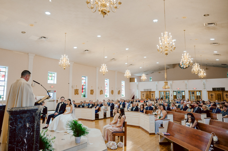 On September 1, 2023 Renee and Sam got married at Maritime Parc located in the center of Liberty State Park where you can get the best view of NYC skyline. Renee and Sam couldn't have asked for a better day, weather in October it was sunny, warm and gorgeous. Renee got ready at her parents' house in Paramus NJ where Renee intimately got ready for her wedding with her parents, two sisters and best friends. Renee's hair and makeup was done by Anna Posokhina from Bridal Squad. Once Renee was all glammed out by Anna Posokhina with help of her mother and two sisters walked into her Justin Alexander wedding dress. With final spray of Jo Malone perfume Renee walked out of her parents' house with her bridesmaids and stepped into her party bus. At the same time Sam was getting ready at Renee's sister's house in Hawthorne NJ with his family and groomsmen. Then Renee and Sam saw each other for the first time down the aisle at Our Lady of the Visitation in Paramus NJ. As soon as Sam saw Renee standing by the entrance of the church started crying. With plenty time for photo we arrived at Liberty State Park where Renee only wanted photos with NYC backdrop even it was staring at the bright sun and squinty eyes, i don't blame her because the view is spectacular and who wouldn't want photos with this gorgeous backdrop of NYC. Cocktail hour started and guests started fill the stairs to third floor of Maritime Parc. Renee and Sam's amazing wedding day at Maritime Parc continued with music provided by live band "The Hook Club" where they set the mood for all night of dancing. And we ended the evening with most amazing NYC skyline with Super moon rising above NYC. Renee and Sam's Maritime Park Jersey City NJ wedding photographed and documented by by Karis | Hey Karis | Catskills, Hudson Valley NY elopement and wedding photographer | Brooklyn NY elopement and wedding photographer | Manhattan NY elopement and wedding photographer | Hey Karis is fun documentary wedding and elopement photographer.