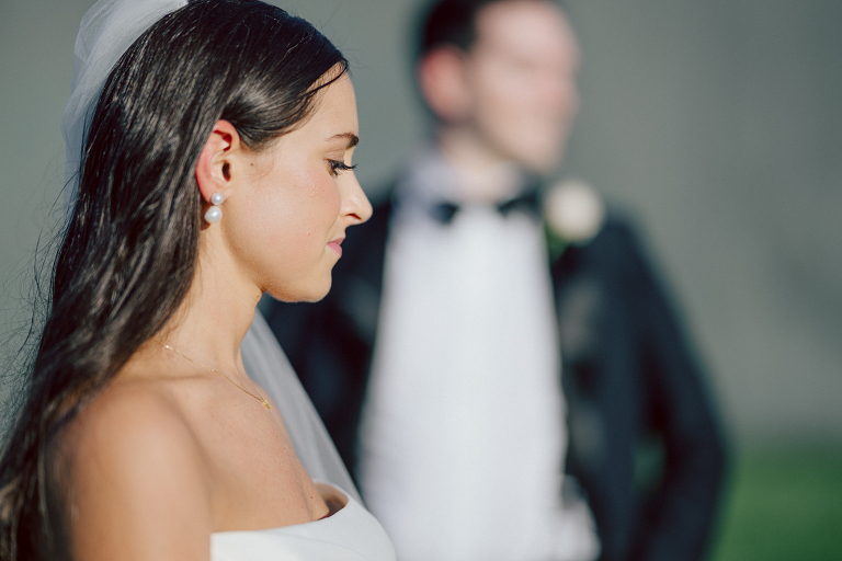 On September 1, 2023 Renee and Sam got married at Maritime Parc located in the center of Liberty State Park where you can get the best view of NYC skyline. Renee and Sam couldn't have asked for a better day, weather in October it was sunny, warm and gorgeous. Renee got ready at her parents' house in Paramus NJ where Renee intimately got ready for her wedding with her parents, two sisters and best friends. Renee's hair and makeup was done by Anna Posokhina from Bridal Squad. Once Renee was all glammed out by Anna Posokhina with help of her mother and two sisters walked into her Justin Alexander wedding dress. With final spray of Jo Malone perfume Renee walked out of her parents' house with her bridesmaids and stepped into her party bus. At the same time Sam was getting ready at Renee's sister's house in Hawthorne NJ with his family and groomsmen. Then Renee and Sam saw each other for the first time down the aisle at Our Lady of the Visitation in Paramus NJ. As soon as Sam saw Renee standing by the entrance of the church started crying. With plenty time for photo we arrived at Liberty State Park where Renee only wanted photos with NYC backdrop even it was staring at the bright sun and squinty eyes, i don't blame her because the view is spectacular and who wouldn't want photos with this gorgeous backdrop of NYC. Cocktail hour started and guests started fill the stairs to third floor of Maritime Parc. Renee and Sam's amazing wedding day at Maritime Parc continued with music provided by live band "The Hook Club" where they set the mood for all night of dancing. And we ended the evening with most amazing NYC skyline with Super moon rising above NYC. Renee and Sam's Maritime Park Jersey City NJ wedding photographed and documented by by Karis | Hey Karis | Catskills, Hudson Valley NY elopement and wedding photographer | Brooklyn NY elopement and wedding photographer | Manhattan NY elopement and wedding photographer | Hey Karis is fun documentary wedding and elopement photographer.