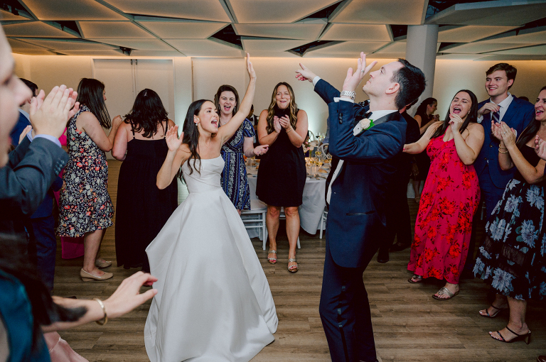 On September 1, 2023 Renee and Sam got married at Maritime Parc located in the center of Liberty State Park where you can get the best view of NYC skyline. Renee and Sam couldn't have asked for a better day, weather in October it was sunny, warm and gorgeous. Renee got ready at her parents' house in Paramus NJ where Renee intimately got ready for her wedding with her parents, two sisters and best friends. Renee's hair and makeup was done by Anna Posokhina from Bridal Squad. Once Renee was all glammed out by Anna Posokhina with help of her mother and two sisters walked into her Justin Alexander wedding dress. With final spray of Jo Malone perfume Renee walked out of her parents' house with her bridesmaids and stepped into her party bus. At the same time Sam was getting ready at Renee's sister's house in Hawthorne NJ with his family and groomsmen. Then Renee and Sam saw each other for the first time down the aisle at Our Lady of the Visitation in Paramus NJ. As soon as Sam saw Renee standing by the entrance of the church started crying. With plenty time for photo we arrived at Liberty State Park where Renee only wanted photos with NYC backdrop even it was staring at the bright sun and squinty eyes, i don't blame her because the view is spectacular and who wouldn't want photos with this gorgeous backdrop of NYC. Cocktail hour started and guests started fill the stairs to third floor of Maritime Parc. Renee and Sam's amazing wedding day at Maritime Parc continued with music provided by live band "The Hook Club" where they set the mood for all night of dancing. And we ended the evening with most amazing NYC skyline with Super moon rising above NYC. Renee and Sam's Maritime Park Jersey City NJ wedding photographed and documented by by Karis | Hey Karis | Catskills, Hudson Valley NY elopement and wedding photographer | Brooklyn NY elopement and wedding photographer | Manhattan NY elopement and wedding photographer | Hey Karis is fun documentary wedding and elopement photographer.
