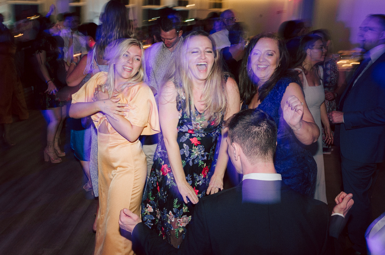 On September 1, 2023 Renee and Sam got married at Maritime Parc located in the center of Liberty State Park where you can get the best view of NYC skyline. Renee and Sam couldn't have asked for a better day, weather in October it was sunny, warm and gorgeous. Renee got ready at her parents' house in Paramus NJ where Renee intimately got ready for her wedding with her parents, two sisters and best friends. Renee's hair and makeup was done by Anna Posokhina from Bridal Squad. Once Renee was all glammed out by Anna Posokhina with help of her mother and two sisters walked into her Justin Alexander wedding dress. With final spray of Jo Malone perfume Renee walked out of her parents' house with her bridesmaids and stepped into her party bus. At the same time Sam was getting ready at Renee's sister's house in Hawthorne NJ with his family and groomsmen. Then Renee and Sam saw each other for the first time down the aisle at Our Lady of the Visitation in Paramus NJ. As soon as Sam saw Renee standing by the entrance of the church started crying. With plenty time for photo we arrived at Liberty State Park where Renee only wanted photos with NYC backdrop even it was staring at the bright sun and squinty eyes, i don't blame her because the view is spectacular and who wouldn't want photos with this gorgeous backdrop of NYC. Cocktail hour started and guests started fill the stairs to third floor of Maritime Parc. Renee and Sam's amazing wedding day at Maritime Parc continued with music provided by live band "The Hook Club" where they set the mood for all night of dancing. And we ended the evening with most amazing NYC skyline with Super moon rising above NYC. Renee and Sam's Maritime Park Jersey City NJ wedding photographed and documented by by Karis | Hey Karis | Catskills, Hudson Valley NY elopement and wedding photographer | Brooklyn NY elopement and wedding photographer | Manhattan NY elopement and wedding photographer | Hey Karis is fun documentary wedding and elopement photographer.
