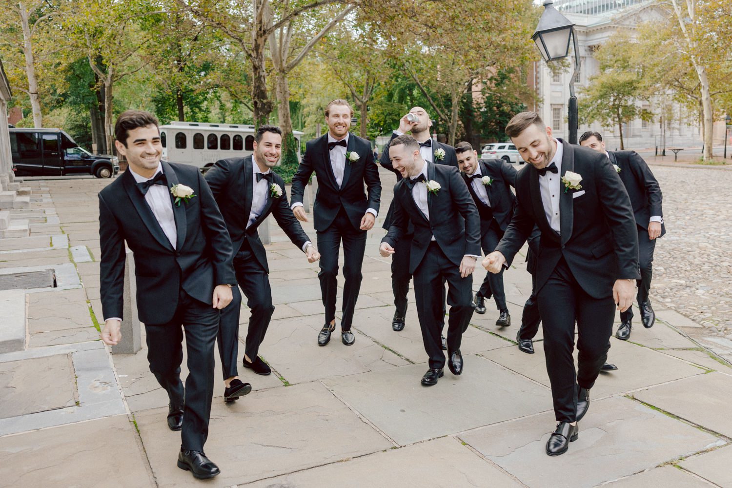 Bianca and Mike's The Union Trust Philadelphia wedding. I met Bianca and Mike at Julie and Thomas's wedding in 2021, Bianca was Julie's bridesmaid and best friend. Bianca and Mike new to book me for their wedding so as soon as they found their dream wedding venue The Union Trust in Philadelphia they emailed me. Honestly these previous couple's referrals are the best because they've already seen me work, familiar with my work and they are my true fans. Bianca got ready onsite at The Union Trust's bridal suit where the lighting was bit wonky with no natural light but hey I make it work! While Bianca was busy getting ready Mike and his buddies were over at Renaissance Hotel Philadelphia. Bianca and Mike also opted out of First Look, Bianca walking down the aisle at St. Augustine’s Philadelphia was when the couple saw each other for the first time and of course their eyes got watery. Bianca and Mike rang the wedding bell at St. Augustine’s Philadelphia and screamed with their arms raised as they exited St. Augustine as husband and wife. It was 4 in the afternoon, everyone loaded on the party bus we drove straight to historic Merchant Exchange Building Philadelphia for photos. The light, the weather was perfect, and surrounded by great people we wrapped up all our formal wedding portraits and now only word PARTY was on everyone's mind including the newly wed Bianca and Mike. Back at The Union Trust Ballroom, florists were busy decorating and entertainment crew was setting up. Together they turned this gorgeous Union Trust Ballroom, into chick and modern vibe. Bianca and Mike entered the ballroom and it was ON for the rest of the evening with party people filling the dance floor at The Union Trust, happily celebrating the union of their favorite people Bianca and Mike. Bianca and Mike's The Union Trust Philadelphia wedding photographed and documented by by Karis | Hey Karis | Catskills, Hudson Valley NY elopement and wedding photographer | Brooklyn NY elopement and wedding photographer | Manhattan NY elopement and wedding photographer | Hey Karis is fun documentary wedding and elopement photographer.