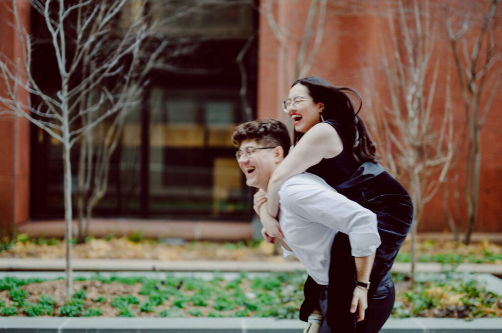 The city streets were refreshingly empty and surreal on an early Saturday morning in chilly December. With all the college students away for winter break, Washington Square Park, surrounded by NYU buildings and dorms, was particularly deserted. Erika and Andrei arrived around 7:30 am, stepping out of their Uber to meet me at the iconic Washington Square Arch. Erika looked stunning in a black velvet romper, while Andrei sported a tuxedo with a "purposely" undone bowtie, creating that effortlessly cool rockstar look for the morning. Together, we ventured through the chilly, deserted streets of Greenwich Village, making our way to Bond Street and concluding the engagement session in the vibrant East Village by the cube. Along the way, we spontaneously paused at corners, benches, and in front of unique buildings, capturing the essence of their love against the backdrop of the city. Erika and Andrei's engagement session in Greenwich Village was truly delightful, and I find myself eagerly anticipating their wedding next year at The Box House Hotel in Brooklyn—a venue that has long been on my bucket list. The blend of the picturesque Greenwich Village streets and the upcoming wedding at such a coveted location promises a celebration filled with love and unforgettable moments. Erika and Andrei's Washington Square Park NYC, Washington Mews NYC, Greenwich Village NYC documented by by Karis | Hey Karis | Destination Wedding Photographer | Manhattan, Catskills, Hudson Valley, Brooklyn and NJ | Destination Elopement, Destination Wedding Photographer | Hey Karis is fun documentary wedding and elopement photographer based in NY, NJ.