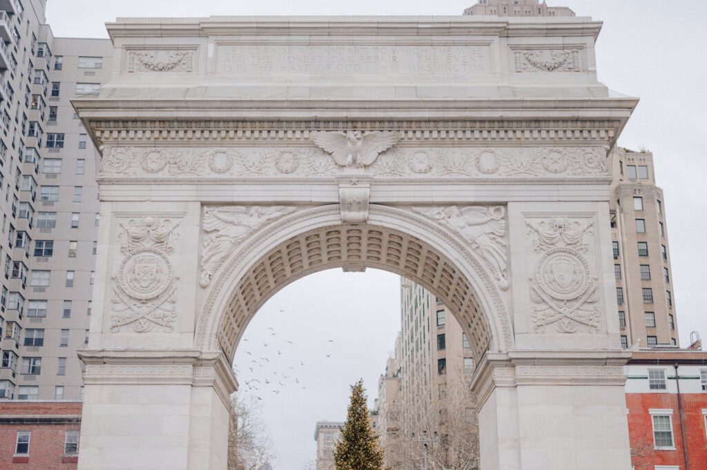 The city streets were refreshingly empty and surreal on an early Saturday morning in chilly December. With all the college students away for winter break, Washington Square Park, surrounded by NYU buildings and dorms, was particularly deserted. Erika and Andrei arrived around 7:30 am, stepping out of their Uber to meet me at the iconic Washington Square Arch. Erika looked stunning in a black velvet romper, while Andrei sported a tuxedo with a "purposely" undone bowtie, creating that effortlessly cool rockstar look for the morning. Together, we ventured through the chilly, deserted streets of Greenwich Village, making our way to Bond Street and concluding the engagement session in the vibrant East Village by the cube. Along the way, we spontaneously paused at corners, benches, and in front of unique buildings, capturing the essence of their love against the backdrop of the city. Erika and Andrei's engagement session in Greenwich Village was truly delightful, and I find myself eagerly anticipating their wedding next year at The Box House Hotel in Brooklyn—a venue that has long been on my bucket list. The blend of the picturesque Greenwich Village streets and the upcoming wedding at such a coveted location promises a celebration filled with love and unforgettable moments. Erika and Andrei's Washington Square Park NYC, Washington Mews NYC, Greenwich Village NYC documented by by Karis | Hey Karis | Destination Wedding Photographer | Manhattan, Catskills, Hudson Valley, Brooklyn and NJ | Destination Elopement, Destination Wedding Photographer | Hey Karis is fun documentary wedding and elopement photographer based in NY, NJ.
