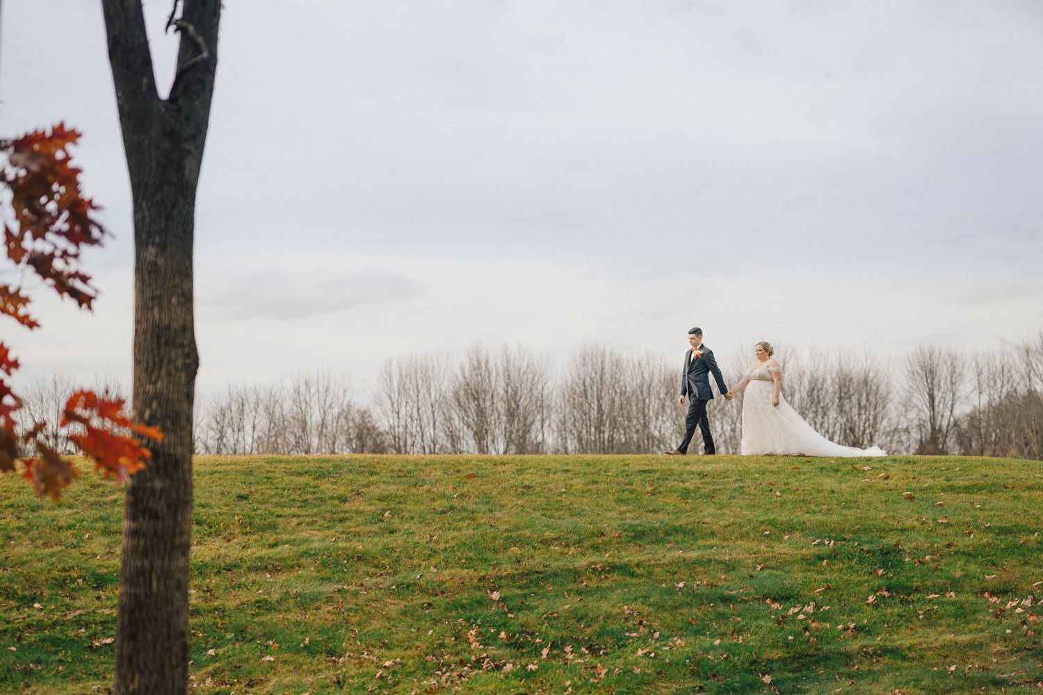Driving to Bear Brook Valley in Fredon Township, NJ, can feel long, but perhaps it was the anticipation of capturing my last wedding of 2023 that made the journey refreshing and surprisingly brisk. Heather and Ryan, the delightful couple at the center of this celebration, added to the joy of the day. With Kelly from Gifted Events overseeing the wedding planning, I knew it was bound to be a smooth and amazing event.

Despite a bit of overcast weather, I was relieved there was no rain. Recalling a previous visit to Bear Brook Valley, where freezing temperatures and strong winds made outdoor photography challenging, I welcomed the calmness of the day. Dealing with wind is always tricky—veils and hair flying everywhere can hinder outdoor photo sessions. Given the choice, I'll gladly opt for an overcast, tranquil day over a windy one.

Kelly and her team were hard at work setting up the venue, ensuring everything ran seamlessly. Meanwhile, Heather prepared for her big day surrounded by friends and family in her bridal suite. The beauty team put the finishing touches on Heather's hair and makeup, while Egor from Live Picture Studios took charge of videography.

As the morning transitioned into the afternoon, an unexpected twist awaited in Heather and Ryan's first look. Heather's brother-in-law donned a fake wedding gown, providing a humorous and surprising moment that I eagerly captured. With the initial jitters out of the way, Heather descended the stairs to meet Ryan for the first time in her wedding dress, creating a heartwarming moment that left Ryan teary-eyed and Heather shyly smiling.

Following the first look, we explored the picturesque Bear Brook Valley for wedding portraits. From the swing to the hills and between the trees, we captured the essence of their special day. A highlight of the session was the adorable MOKE, Bear Brook Valley's 20th-century Caribbean collectible car reinvented as a 21st-century all-green electric car. With its vibrant yellow color, the MOKE added a playful touch to the photos as we captured moments both inside and outside the charming vehicle.

With the photo session complete, it was time for the main event—the wedding ceremony at Bear Brook Valley's barn, marking what I believe was the venue's very first ceremony of this kind.

The festivities continued into the reception, where Heather and Ryan surprised their guests with a visit from the Devil's Mascot, showcasing their shared enthusiasm as huge Devils fans. The mascot joined the couple and their guests, dancing and mingling for about 30 minutes, leaving a lasting impression on the celebration.

The wedding day concluded with a dazzling sparkler exit, creating a magical and memorable end to Heather and Ryan's celebration at Bear Brook Valley.
 
Heather and Ryan's Bear Brook Valley wedding documented by by Karis | Hey Karis | Destination Wedding Photographer | Manhattan, Catskills, Hudson Valley, Brooklyn and NJ | Destination Elopement, Destination Wedding Photographer | Hey Karis is fun documentary wedding and elopement photographer based in NY, NJ.
