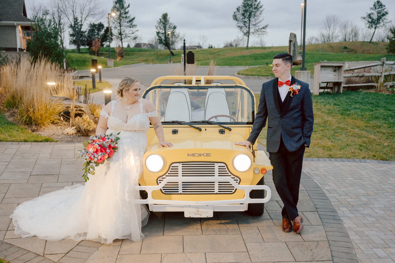 Driving to Bear Brook Valley in Fredon Township, NJ, can feel long, but perhaps it was the anticipation of capturing my last wedding of 2023 that made the journey refreshing and surprisingly brisk. Heather and Ryan, the delightful couple at the center of this celebration, added to the joy of the day. With Kelly from Gifted Events overseeing the wedding planning, I knew it was bound to be a smooth and amazing event.

Despite a bit of overcast weather, I was relieved there was no rain. Recalling a previous visit to Bear Brook Valley, where freezing temperatures and strong winds made outdoor photography challenging, I welcomed the calmness of the day. Dealing with wind is always tricky—veils and hair flying everywhere can hinder outdoor photo sessions. Given the choice, I'll gladly opt for an overcast, tranquil day over a windy one.

Kelly and her team were hard at work setting up the venue, ensuring everything ran seamlessly. Meanwhile, Heather prepared for her big day surrounded by friends and family in her bridal suite. The beauty team put the finishing touches on Heather's hair and makeup, while Egor from Live Picture Studios took charge of videography.

As the morning transitioned into the afternoon, an unexpected twist awaited in Heather and Ryan's first look. Heather's brother-in-law donned a fake wedding gown, providing a humorous and surprising moment that I eagerly captured. With the initial jitters out of the way, Heather descended the stairs to meet Ryan for the first time in her wedding dress, creating a heartwarming moment that left Ryan teary-eyed and Heather shyly smiling.

Following the first look, we explored the picturesque Bear Brook Valley for wedding portraits. From the swing to the hills and between the trees, we captured the essence of their special day. A highlight of the session was the adorable MOKE, Bear Brook Valley's 20th-century Caribbean collectible car reinvented as a 21st-century all-green electric car. With its vibrant yellow color, the MOKE added a playful touch to the photos as we captured moments both inside and outside the charming vehicle.

With the photo session complete, it was time for the main event—the wedding ceremony at Bear Brook Valley's barn, marking what I believe was the venue's very first ceremony of this kind.

The festivities continued into the reception, where Heather and Ryan surprised their guests with a visit from the Devil's Mascot, showcasing their shared enthusiasm as huge Devils fans. The mascot joined the couple and their guests, dancing and mingling for about 30 minutes, leaving a lasting impression on the celebration.

The wedding day concluded with a dazzling sparkler exit, creating a magical and memorable end to Heather and Ryan's celebration at Bear Brook Valley.
 
Heather and Ryan's Bear Brook Valley wedding documented by by Karis | Hey Karis | Destination Wedding Photographer | Manhattan, Catskills, Hudson Valley, Brooklyn and NJ | Destination Elopement, Destination Wedding Photographer | Hey Karis is fun documentary wedding and elopement photographer based in NY, NJ.