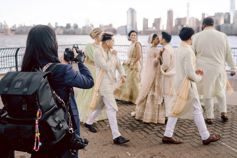 I first crossed paths with Xavier a few years back at Danny and Andy's wedding, where he stood as one of the groomsmen at The Ryland Inn in 2021. When Xavier and Priya's own wedding day approached, I was deeply honored that he remembered me and reached out to discuss capturing their special day.
Meeting Priya and Xavier together during their engagement session in Princeton, NJ was an essential part of my process. It allowed me to delve into their personalities and witness the beautiful chemistry they shared. Engagements sessions, for me, serve as a cornerstone in establishing a genuine connection with my couples before the main event.

Priya and Xavier both started the wedding day at the Hyatt Regency in Jersey City, a venue boasting panoramic views of the Hudson River and the iconic Manhattan skyline. Against this breathtaking backdrop, they readied themselves, shared a heartwarming first look along the Hudson River Waterfront Walkway, then shortly after Priya and Xavier's family and friends joined them for photos.
As Priya watched from a balcony, Xavier's Baraat procession unfolded below, a lively affair marked by music, drums, and joyous celebrations. Following the Baraat wedding guests ascended to the wedding ceremony room at the Hyatt Regency, where a beautifully adorned Mandap awaited their union.

The cocktail hour tantalized guests with an array of delicious Indian cuisine, setting the stage for the grand entrance into the candlelit reception hall. Priya and Xavier stepped in, resplendent in their evening attire, launching into their first dance. This was followed by the traditional Filipino money dance,

Throughout the evening, dance performances, heartfelt parent dances, and touching speeches filled the air with love and laughter. Priya and Xavier's faces radiated with pure joy, reflecting the love that enveloped them on their special day.

Priya and Xavier Hyatt Regency Jersey City NJ wedding documented by by Karis | Hey Karis | Destination Wedding Photographer | Manhattan, Catskills, Hudson Valley, Brooklyn and NJ | Destination Elopement, Destination Wedding Photographer | Hey Karis is fun documentary wedding and elopement photographer based in NY, NJ.