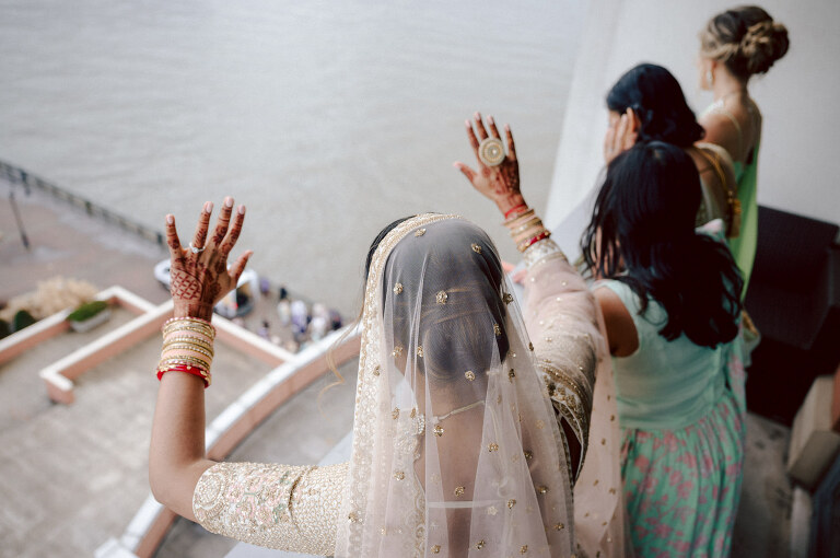 I first crossed paths with Xavier a few years back at Danny and Andy's wedding, where he stood as one of the groomsmen at The Ryland Inn in 2021. When Xavier and Priya's own wedding day approached, I was deeply honored that he remembered me and reached out to discuss capturing their special day.
Meeting Priya and Xavier together during their engagement session in Princeton, NJ was an essential part of my process. It allowed me to delve into their personalities and witness the beautiful chemistry they shared. Engagements sessions, for me, serve as a cornerstone in establishing a genuine connection with my couples before the main event.

Priya and Xavier both started the wedding day at the Hyatt Regency in Jersey City, a venue boasting panoramic views of the Hudson River and the iconic Manhattan skyline. Against this breathtaking backdrop, they readied themselves, shared a heartwarming first look along the Hudson River Waterfront Walkway, then shortly after Priya and Xavier's family and friends joined them for photos.
As Priya watched from a balcony, Xavier's Baraat procession unfolded below, a lively affair marked by music, drums, and joyous celebrations. Following the Baraat wedding guests ascended to the wedding ceremony room at the Hyatt Regency, where a beautifully adorned Mandap awaited their union.

The cocktail hour tantalized guests with an array of delicious Indian cuisine, setting the stage for the grand entrance into the candlelit reception hall. Priya and Xavier stepped in, resplendent in their evening attire, launching into their first dance. This was followed by the traditional Filipino money dance,

Throughout the evening, dance performances, heartfelt parent dances, and touching speeches filled the air with love and laughter. Priya and Xavier's faces radiated with pure joy, reflecting the love that enveloped them on their special day.

Priya and Xavier Hyatt Regency Jersey City NJ wedding documented by by Karis | Hey Karis | Destination Wedding Photographer | Manhattan, Catskills, Hudson Valley, Brooklyn and NJ | Destination Elopement, Destination Wedding Photographer | Hey Karis is fun documentary wedding and elopement photographer based in NY, NJ.
