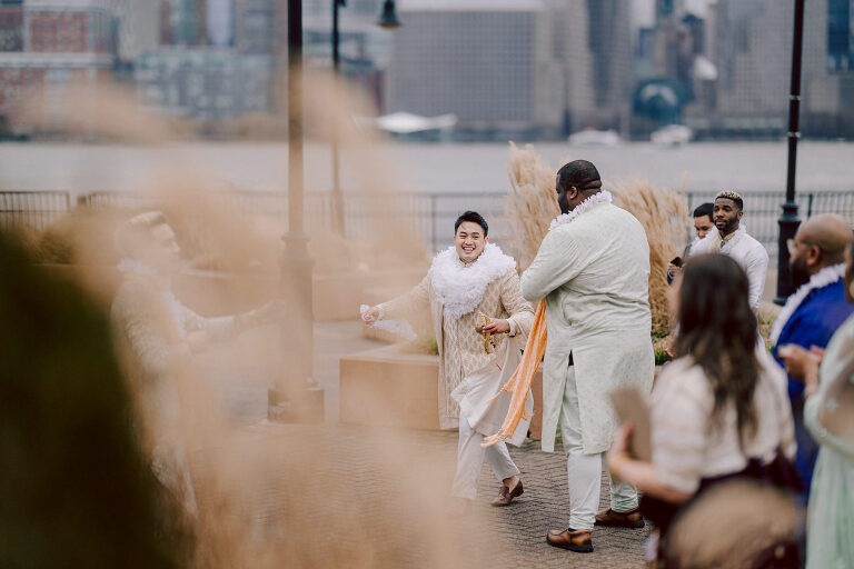 I first crossed paths with Xavier a few years back at Danny and Andy's wedding, where he stood as one of the groomsmen at The Ryland Inn in 2021. When Xavier and Priya's own wedding day approached, I was deeply honored that he remembered me and reached out to discuss capturing their special day.
Meeting Priya and Xavier together during their engagement session in Princeton, NJ was an essential part of my process. It allowed me to delve into their personalities and witness the beautiful chemistry they shared. Engagements sessions, for me, serve as a cornerstone in establishing a genuine connection with my couples before the main event.

Priya and Xavier both started the wedding day at the Hyatt Regency in Jersey City, a venue boasting panoramic views of the Hudson River and the iconic Manhattan skyline. Against this breathtaking backdrop, they readied themselves, shared a heartwarming first look along the Hudson River Waterfront Walkway, then shortly after Priya and Xavier's family and friends joined them for photos.
As Priya watched from a balcony, Xavier's Baraat procession unfolded below, a lively affair marked by music, drums, and joyous celebrations. Following the Baraat wedding guests ascended to the wedding ceremony room at the Hyatt Regency, where a beautifully adorned Mandap awaited their union.

The cocktail hour tantalized guests with an array of delicious Indian cuisine, setting the stage for the grand entrance into the candlelit reception hall. Priya and Xavier stepped in, resplendent in their evening attire, launching into their first dance. This was followed by the traditional Filipino money dance,

Throughout the evening, dance performances, heartfelt parent dances, and touching speeches filled the air with love and laughter. Priya and Xavier's faces radiated with pure joy, reflecting the love that enveloped them on their special day.

Priya and Xavier Hyatt Regency Jersey City NJ wedding documented by by Karis | Hey Karis | Destination Wedding Photographer | Manhattan, Catskills, Hudson Valley, Brooklyn and NJ | Destination Elopement, Destination Wedding Photographer | Hey Karis is fun documentary wedding and elopement photographer based in NY, NJ.